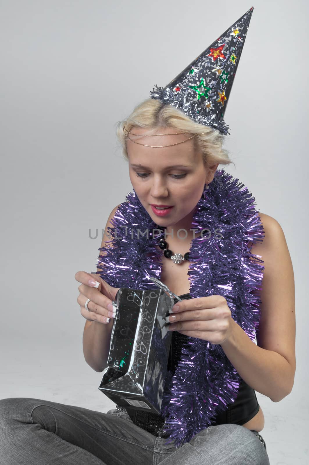 Young and beautiful girl with gifts waiting for the Christmas and New Year