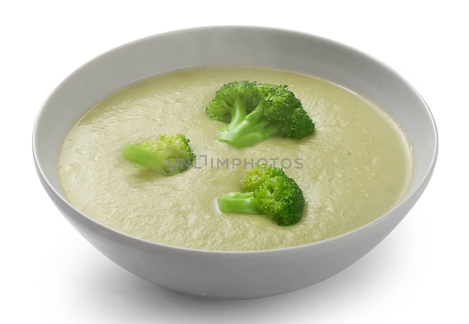 White bowl with cream soup and broccoli