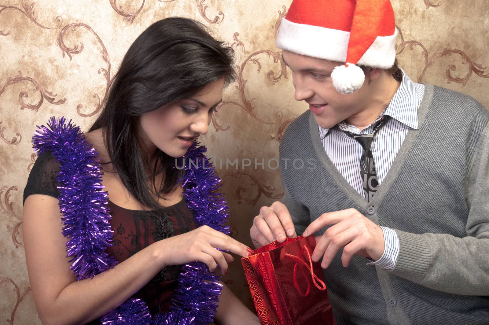 Young and beautiful couple exchanged Christmas gifts