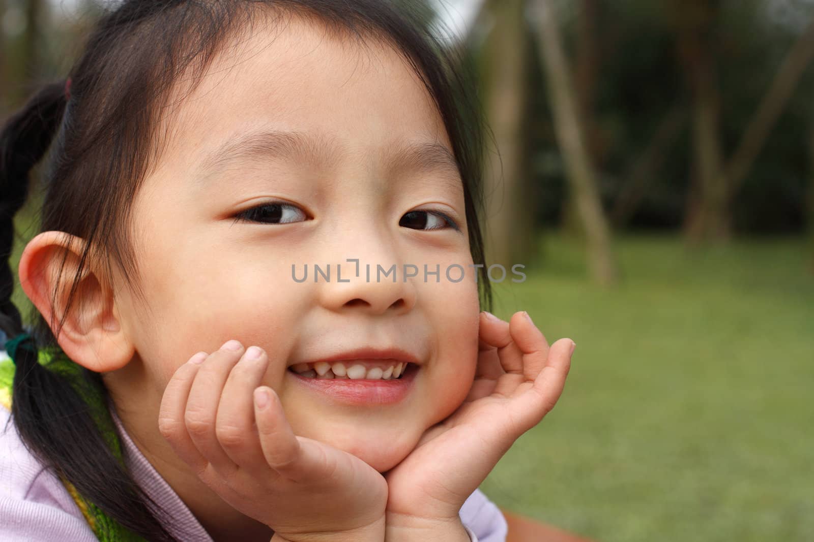 4 year old Chinese girl pretending to be model in a Beijing Park