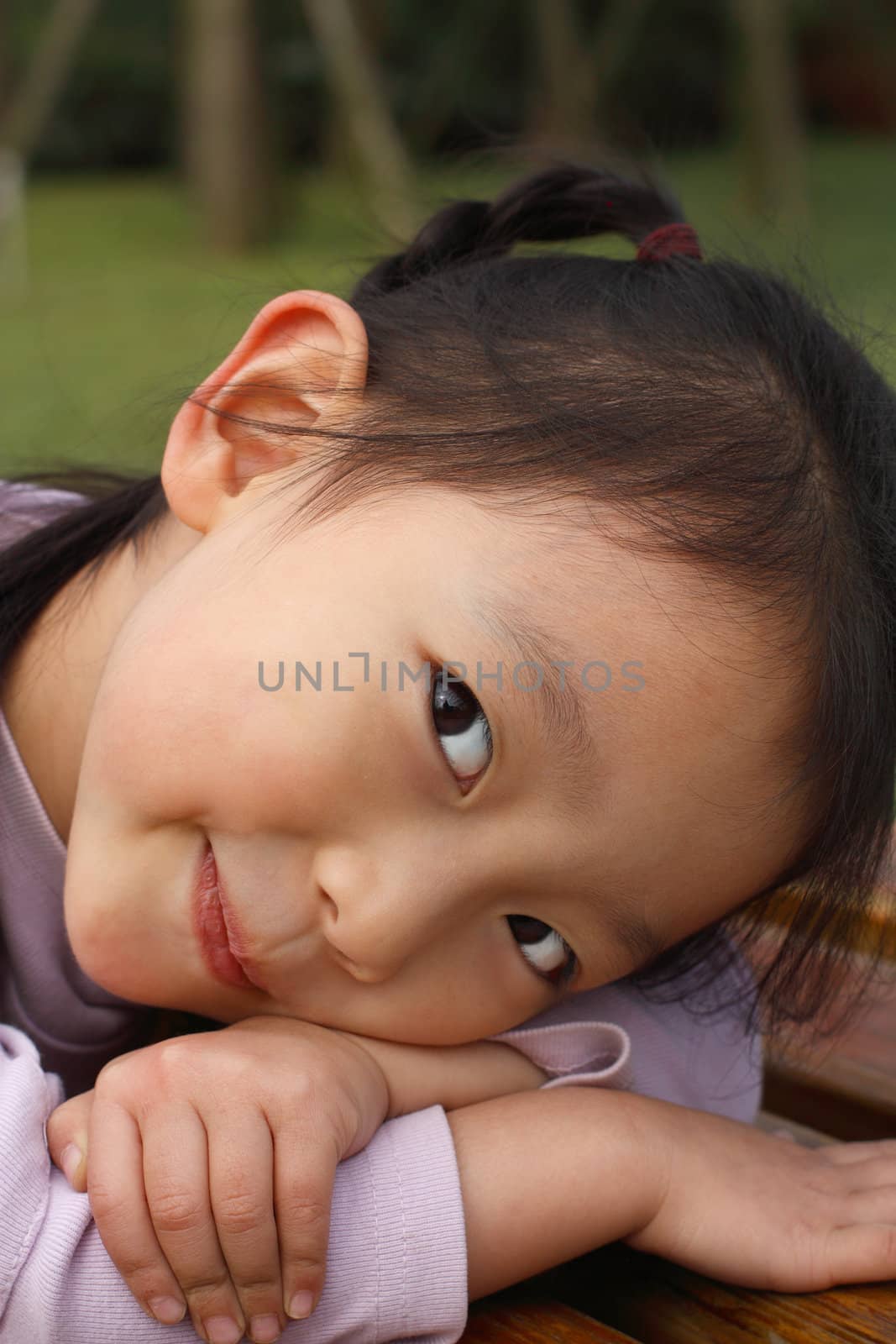 4 year old Chinese girl pretending to be model in a Beijing Park