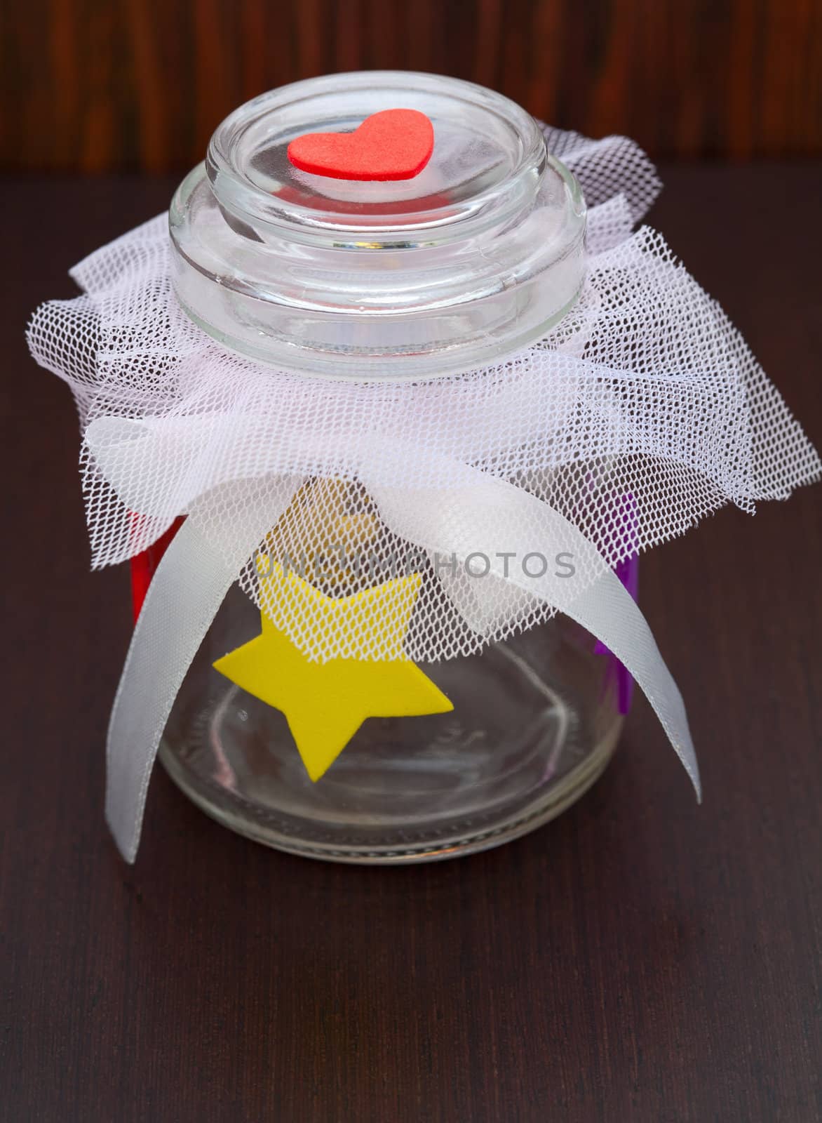 empty jar with a bow on a wooden background