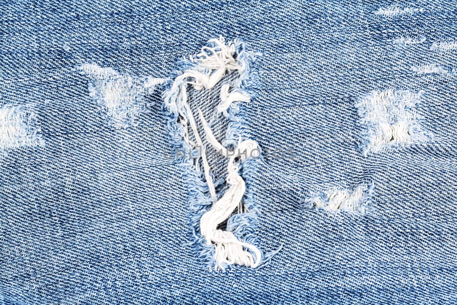 Blue denim jeans hole macro by RawGroup