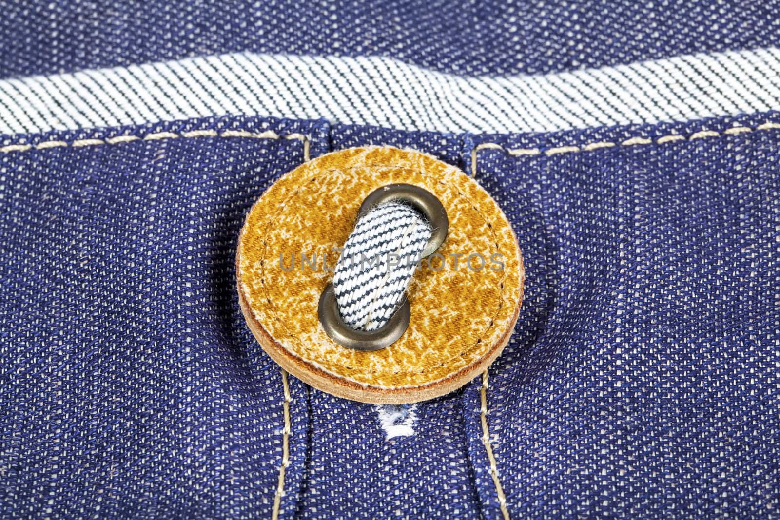 Buttom on jeans textile closeup by RawGroup