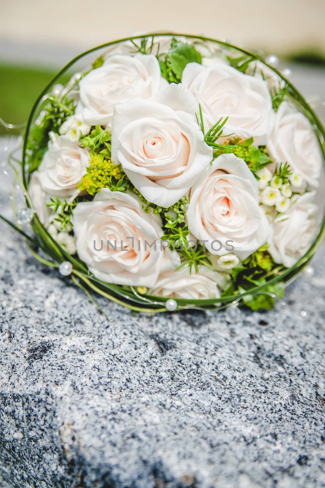 Bridal bouquet with pink roses on a stone