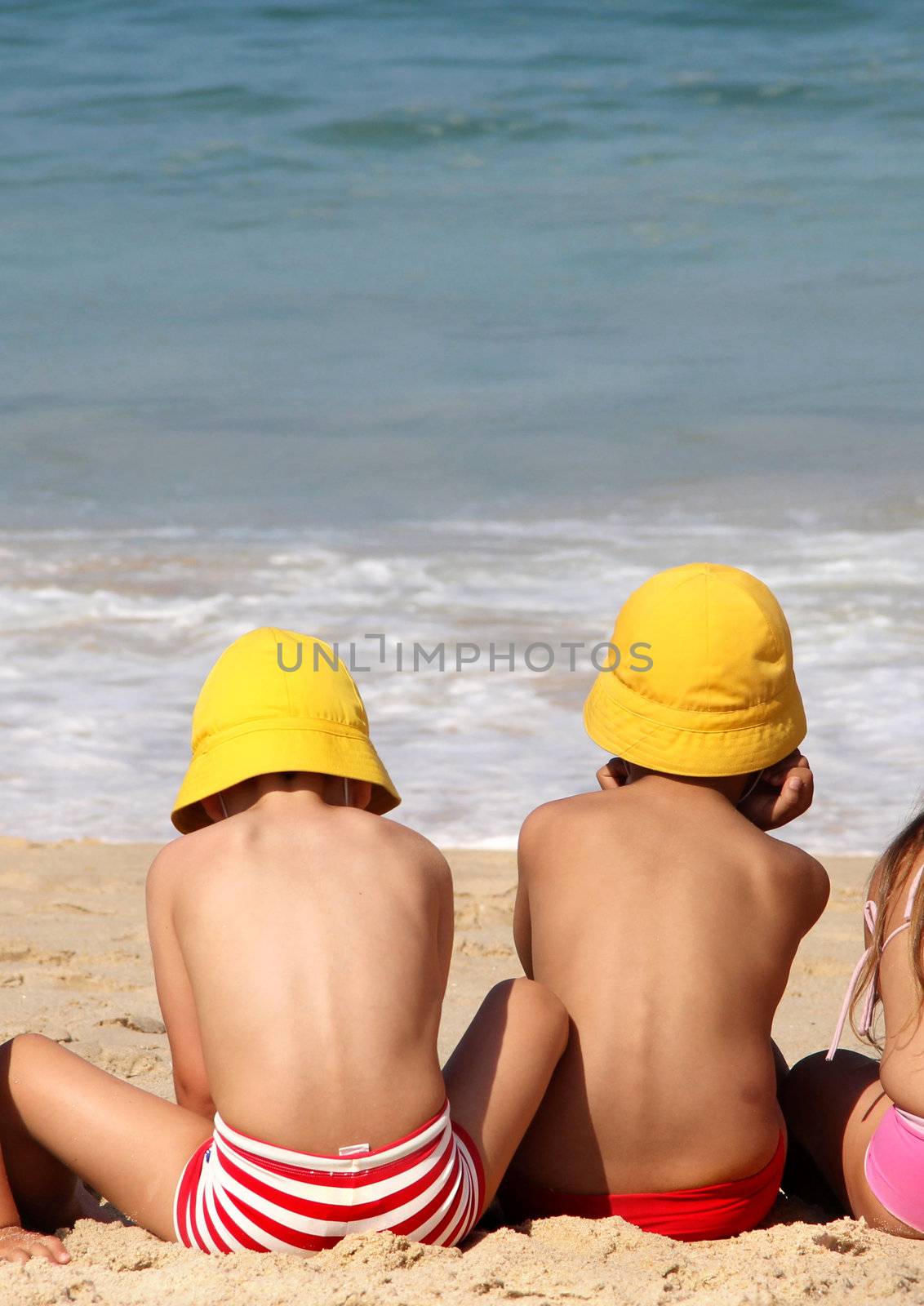 Cute small children on the beach by tanouchka