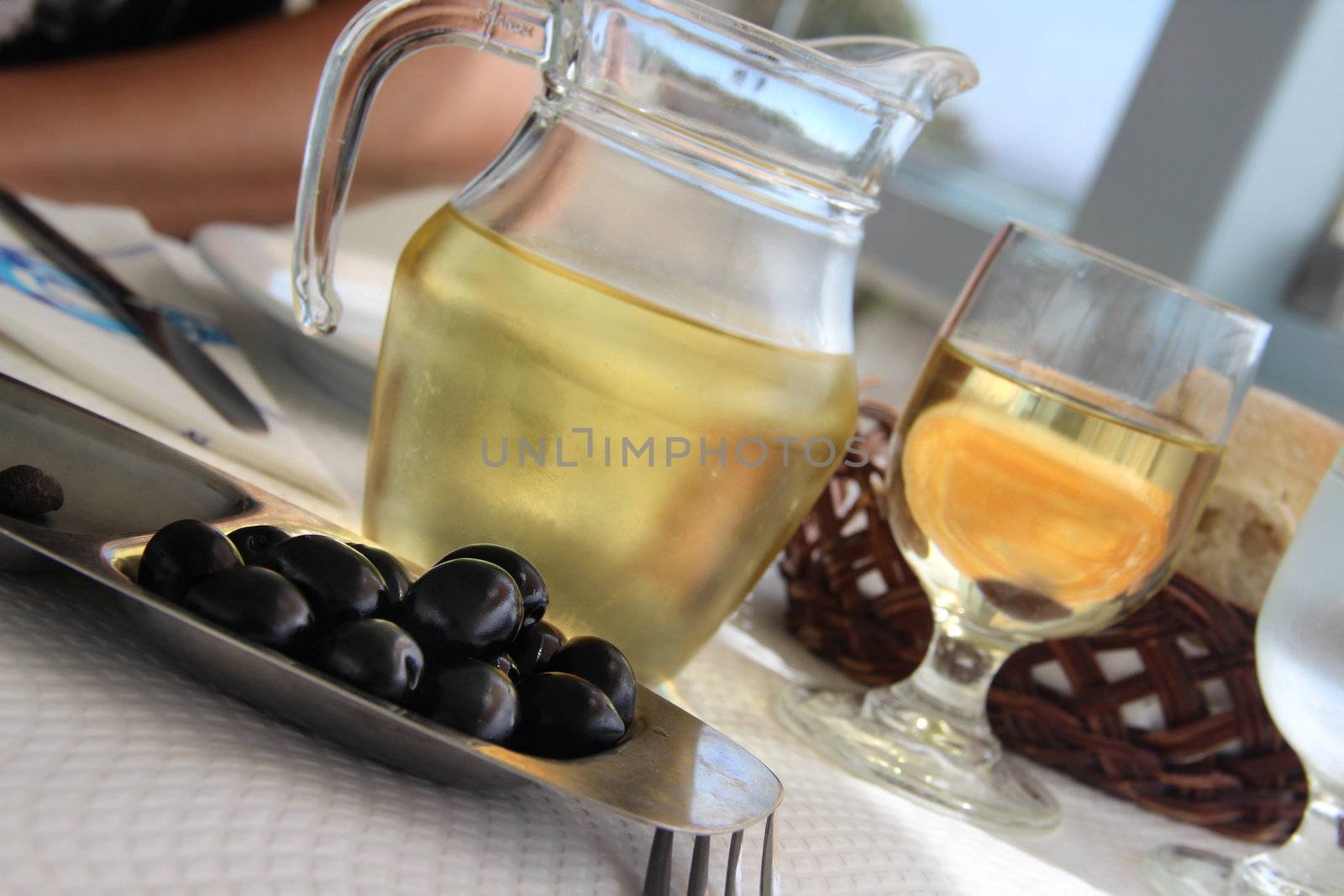 Mediterranean white wine and black olives 