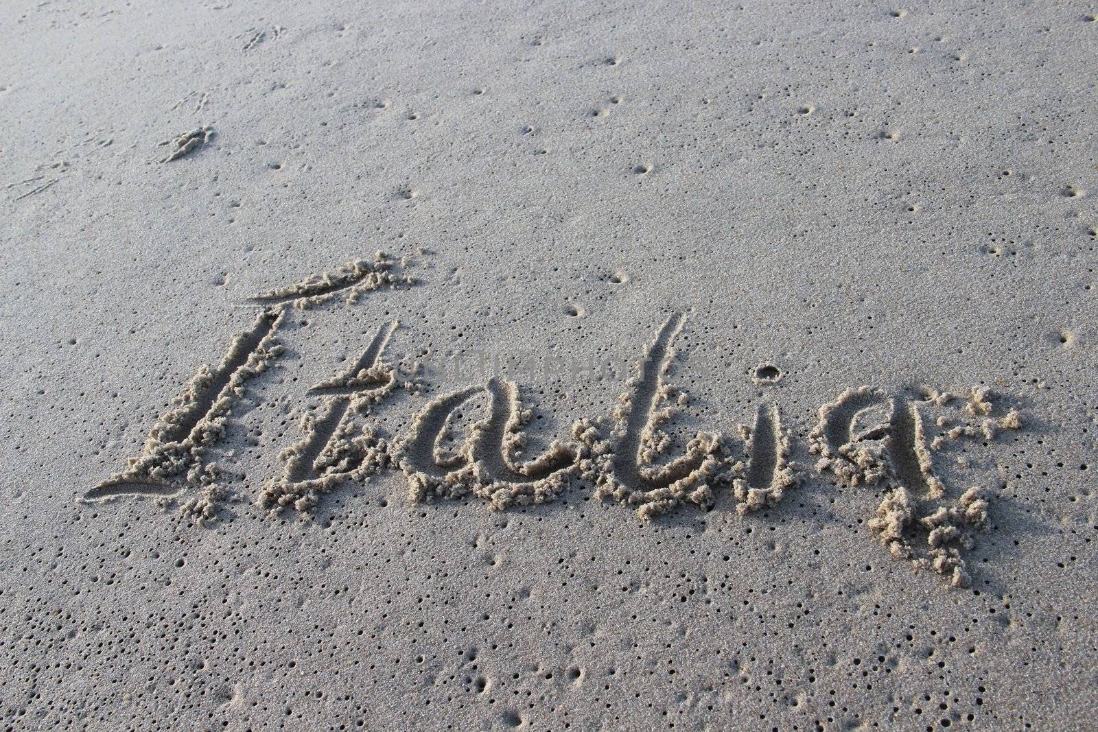 Inscription Italia on the wet sand