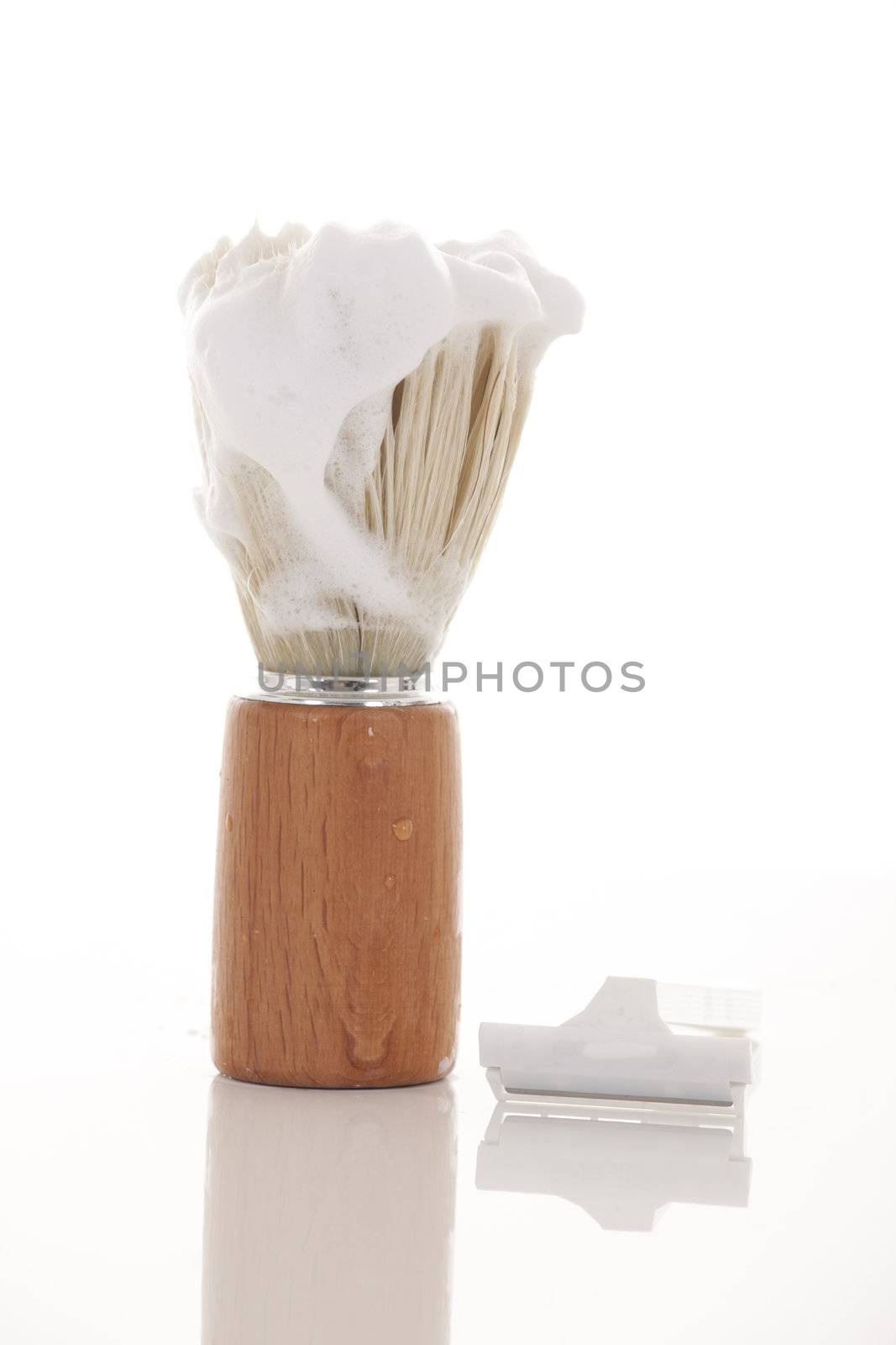 Retro badger shaving brush with a dollop of shaving cream.