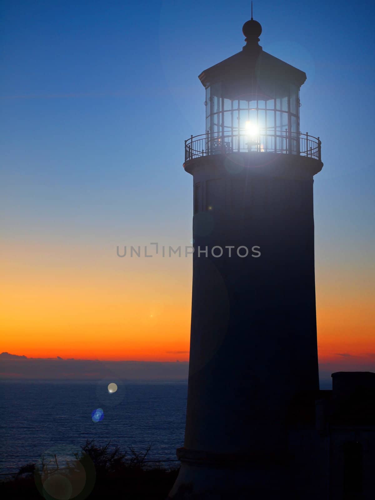 Light Shining in the North Head Lighthouse on the Washington Coast at Sunset