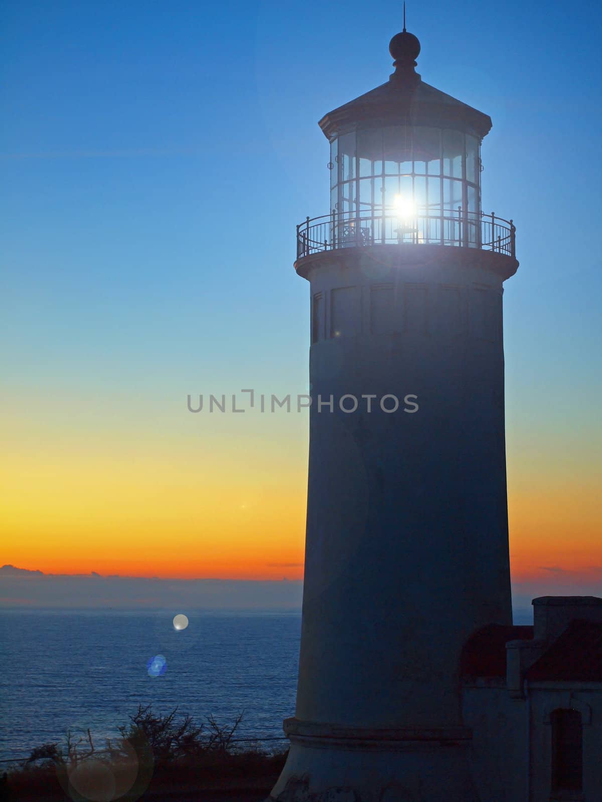 Light Shining in the North Head Lighthouse on the Washington Coast at Sunset