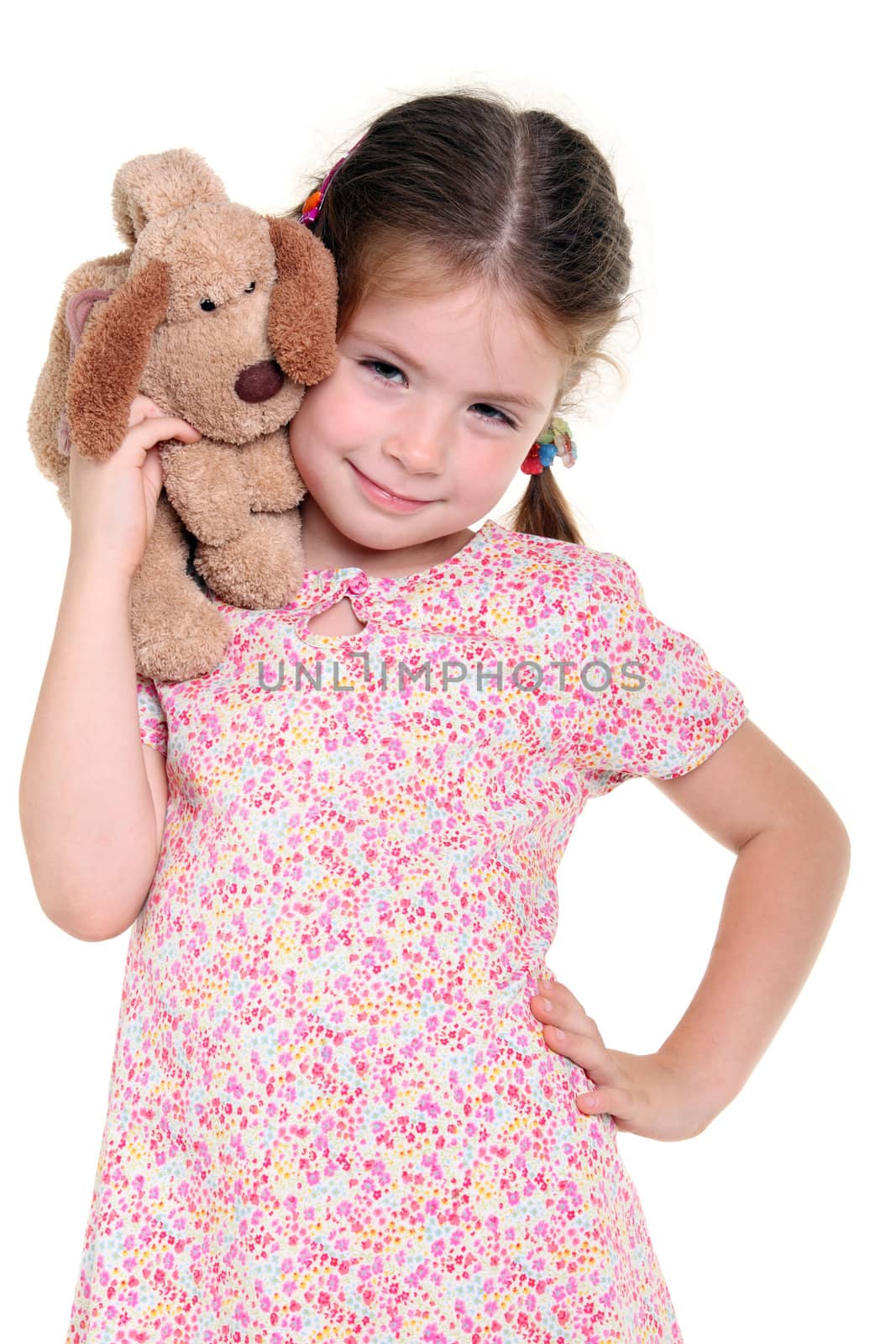 Little girl with a soft toy on the white background
