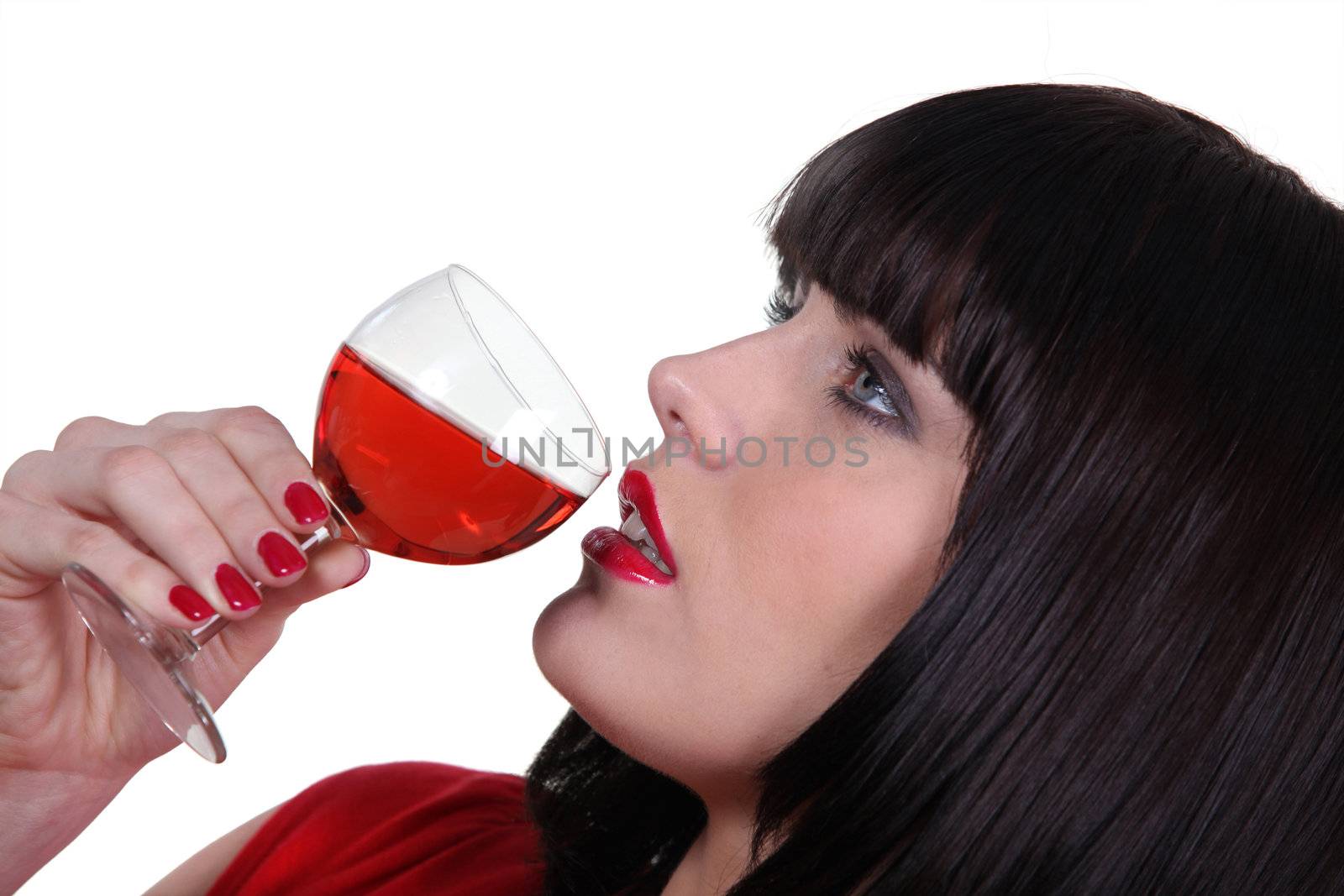Striking shot of a woman drinking a glass of wine