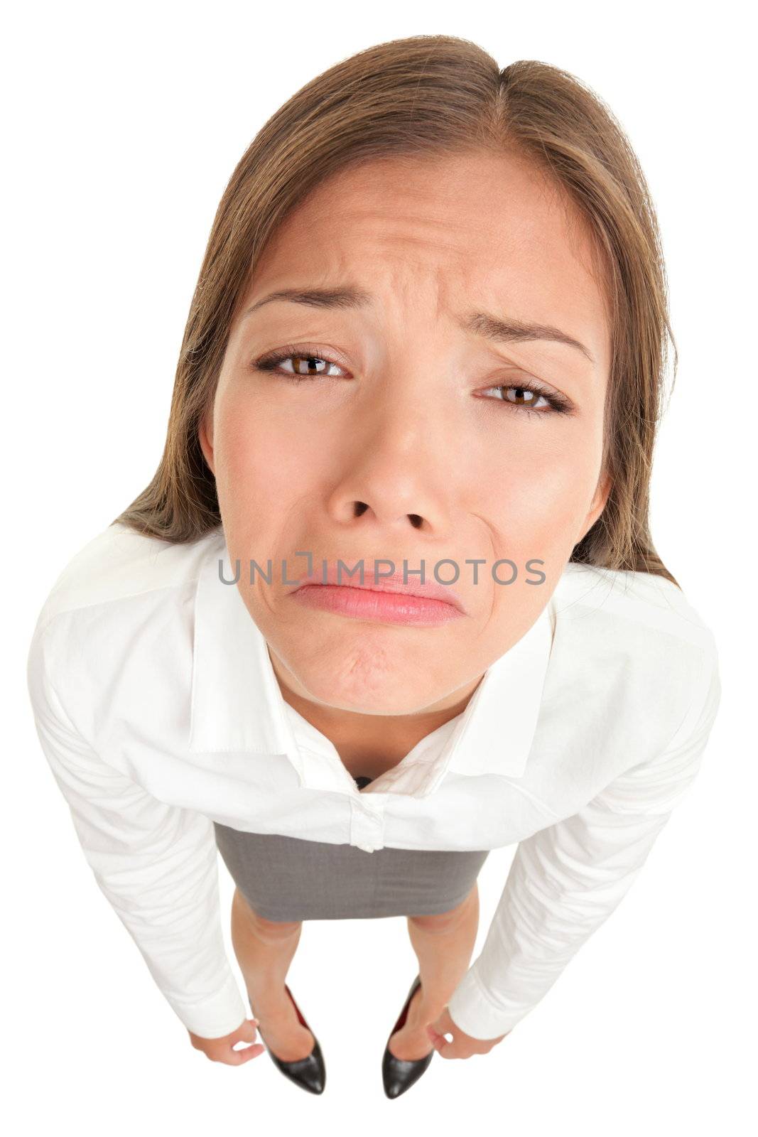 Sad crying disappointed funny business woman in high angle view isolated on white background. Multicultural Asian Caucasian businesswoman looking unhappy isolated on white background.