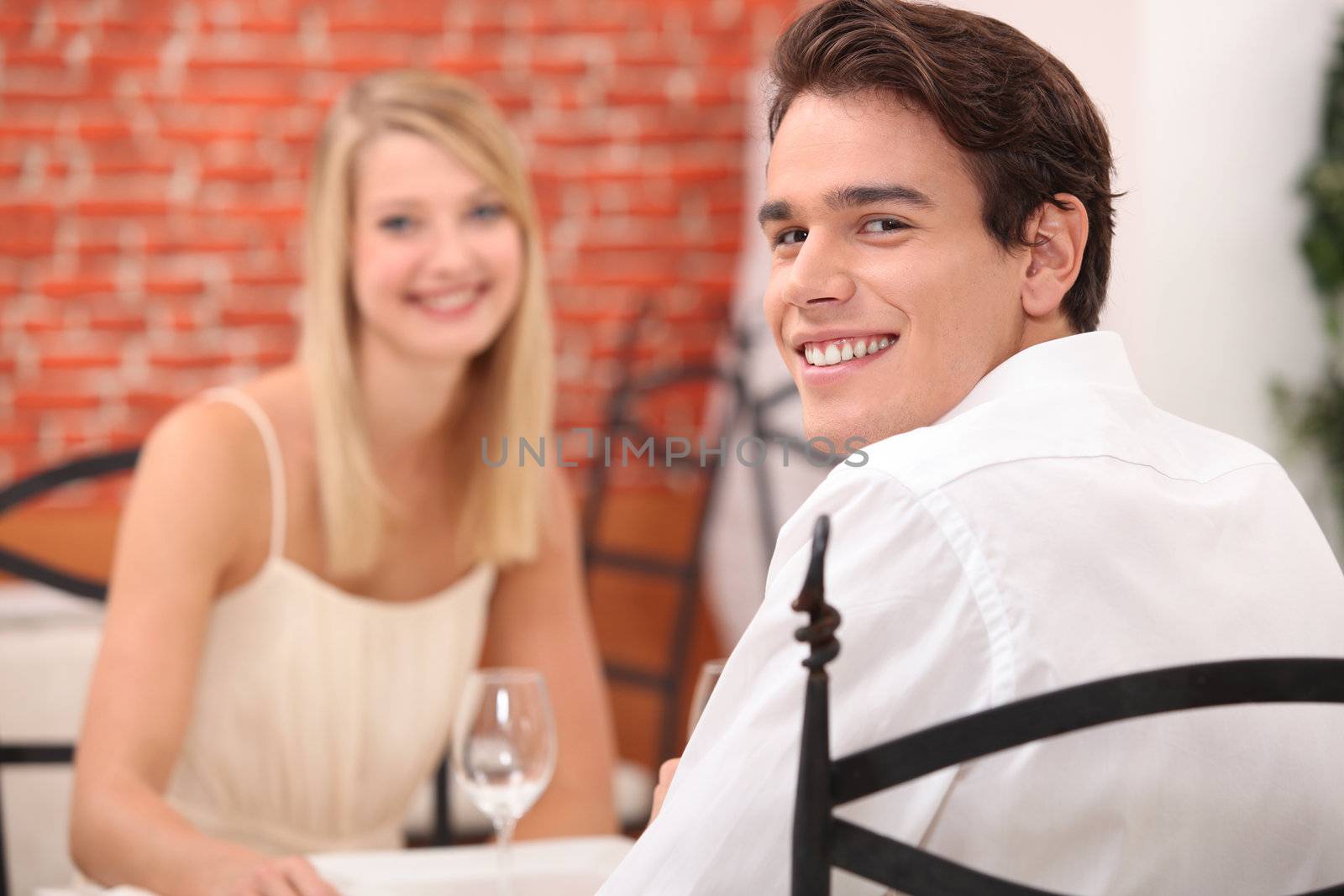 couple having a romantic dinner in a restaurant by phovoir