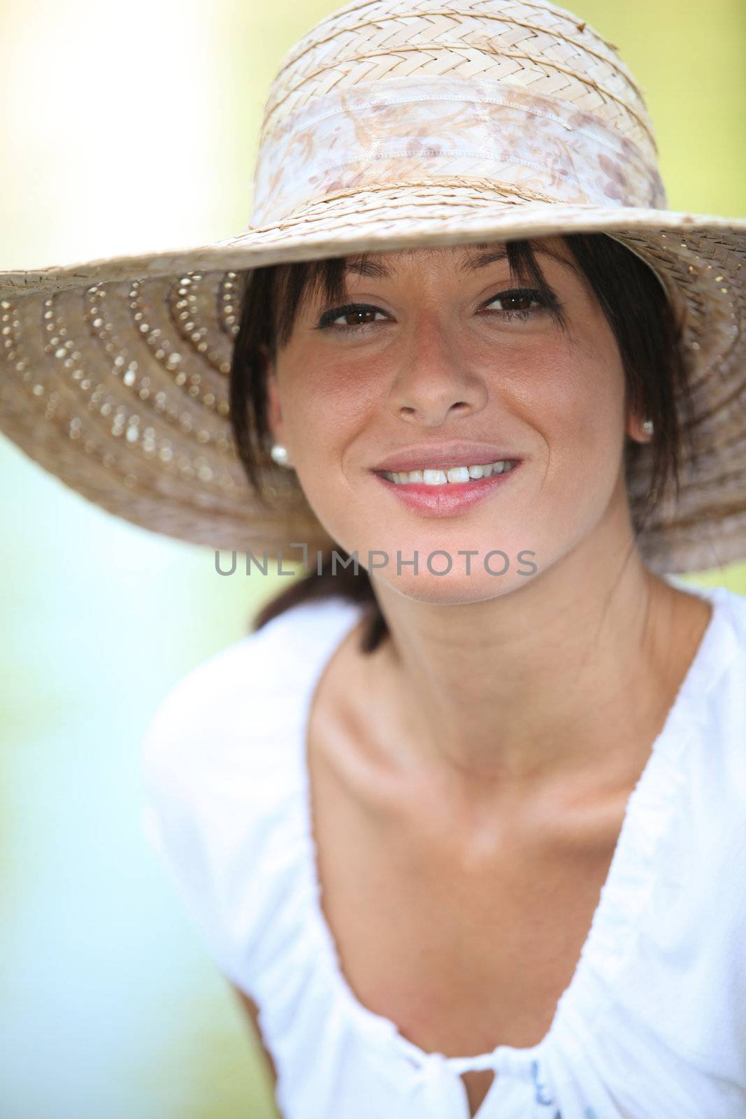 30 years old brunette wearing a straw hat and a summer dress by phovoir