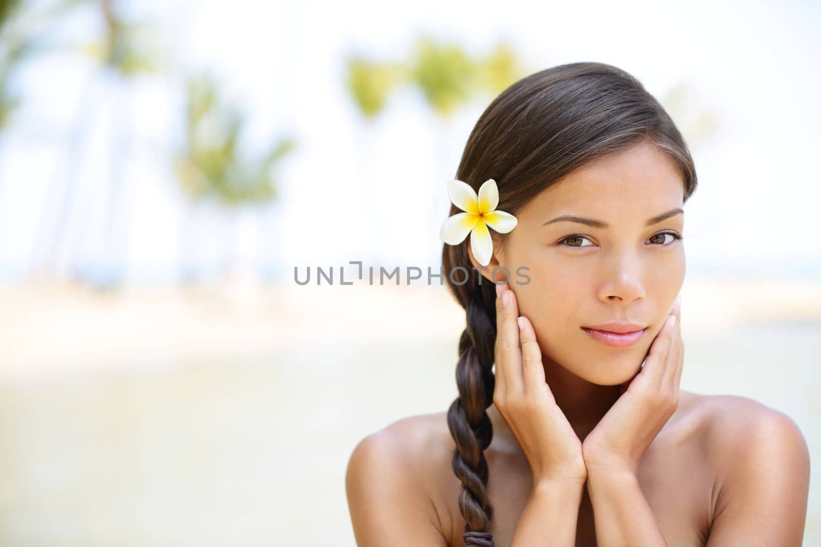 Wellness beauty portrait. Serene multicultural woman outdoors at tropical luxury spa resort. Young mixed race Asian Caucasian female model on Hawaii.
