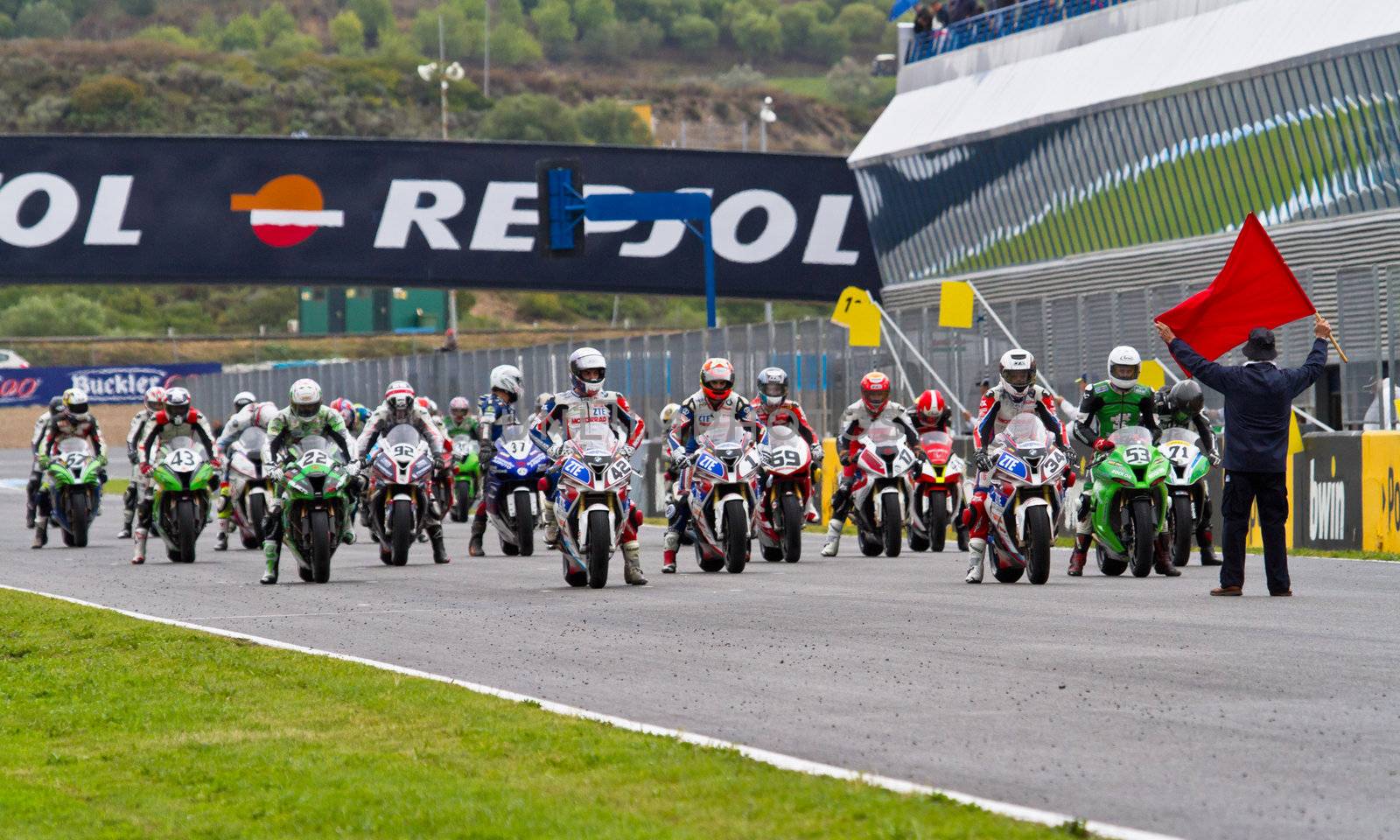 JEREZ DE LA FRONTERA, SPAIN - NOV 20: Motorbike competitors begin the Stock Extreme race in the CEV Championship  on November 20, 2011 in Jerez de la Frontera, Spain