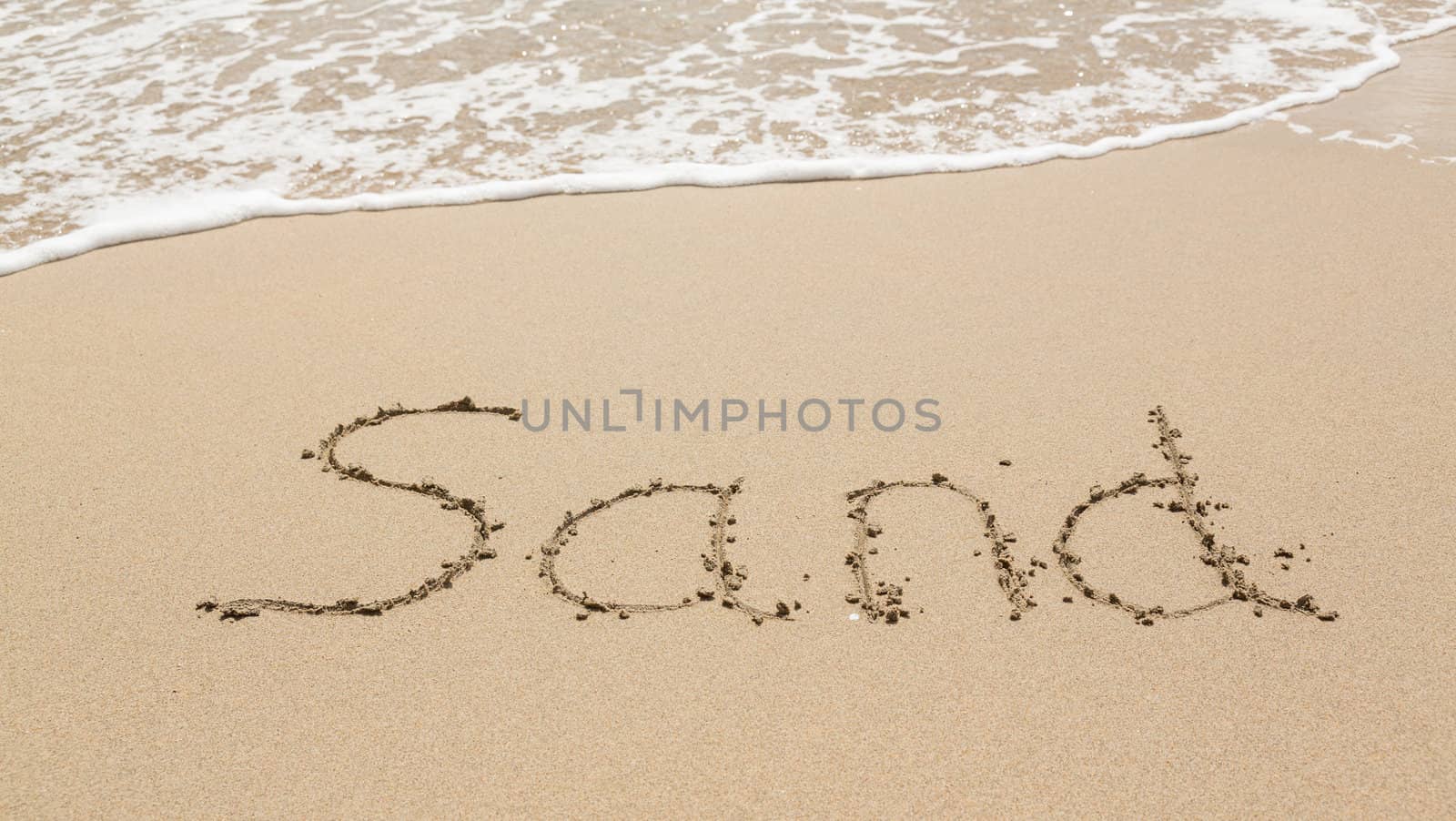 Sand drawing on warm beach by ocean surf in Caribbean spelling Sand