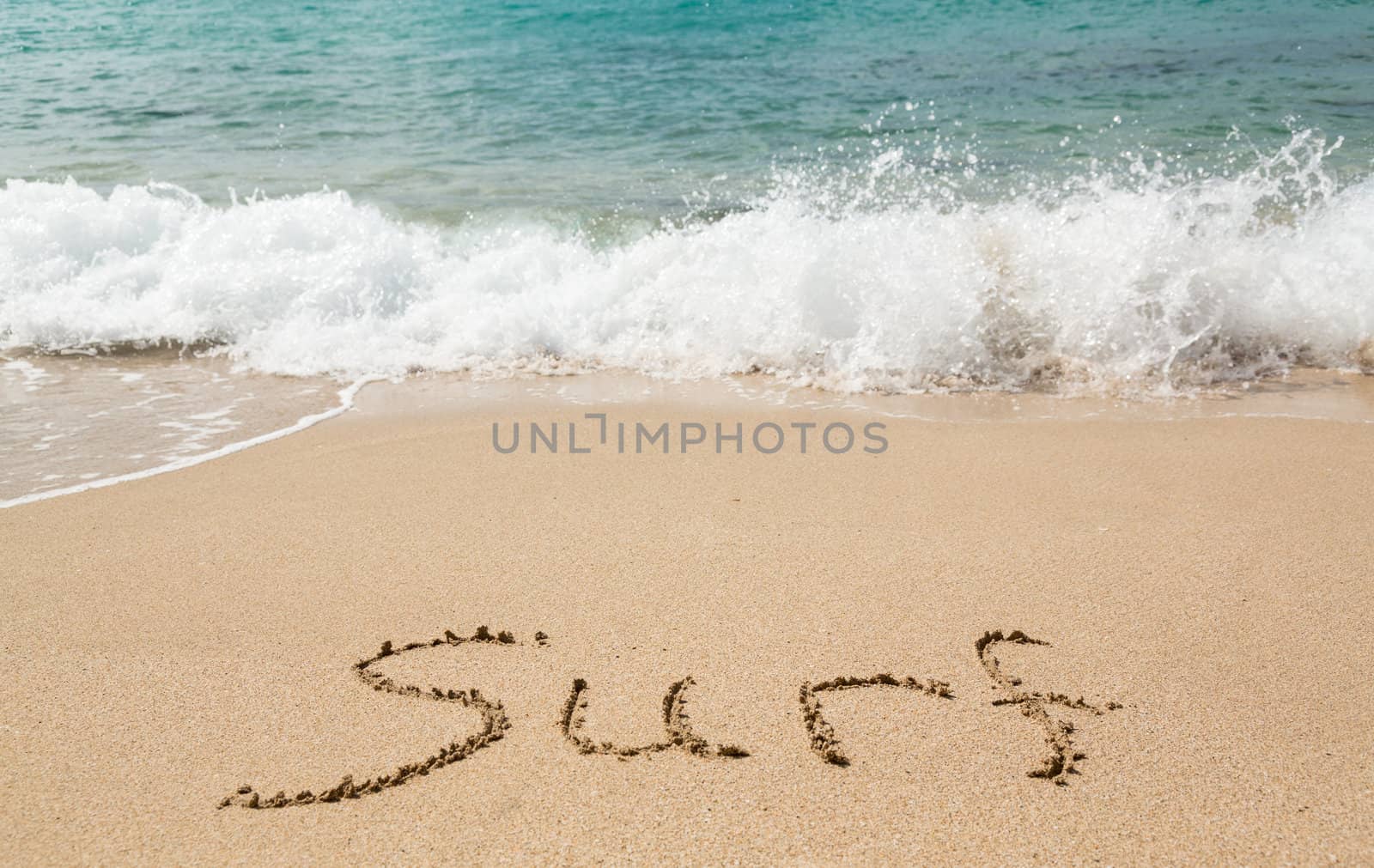 Sand drawing on warm beach by ocean surf in Caribbean spelling surf