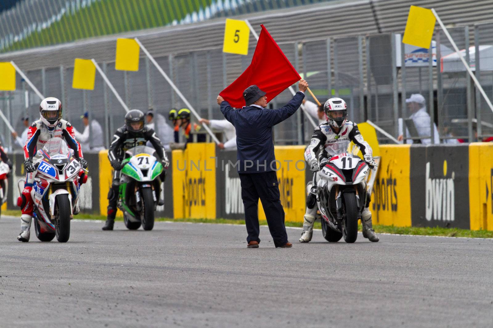 JEREZ DE LA FRONTERA, SPAIN - NOV 20: Motorbike competitors begin the Stock Extreme race in the CEV Championship  on November 20, 2011 in Jerez de la Frontera, Spain