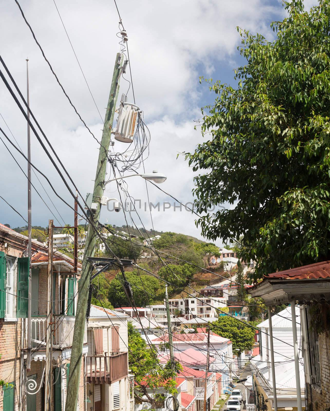Complicated wiring forms tangled mess on power pole with light and camera in Charlotte Amalie St Thomas