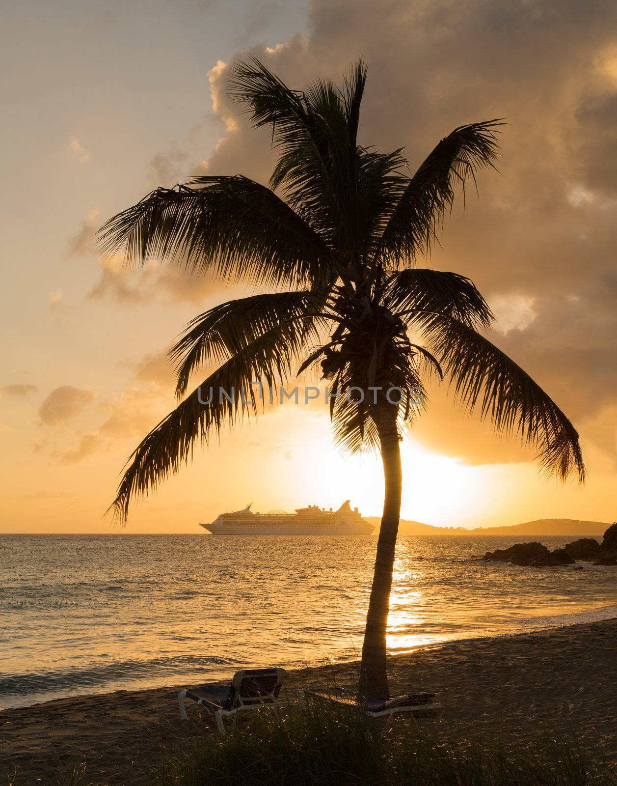 Cruise ship leaves Charlotte Amalie at sunset past Frenchmans bay on St Thomas USVI