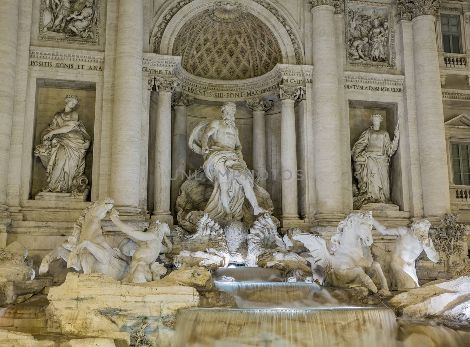 Night time floodlit details of statues in Trevi fountain in Rome Italy