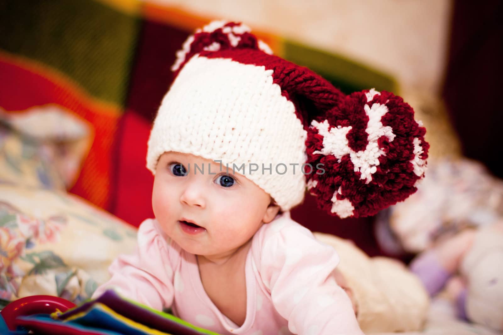 cute little baby in wool hat with big pompoms