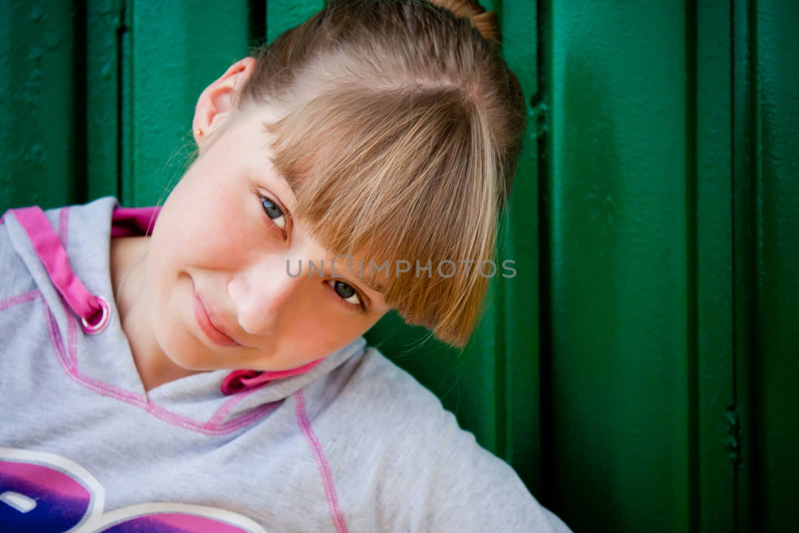 smilingteenage girl on a green background