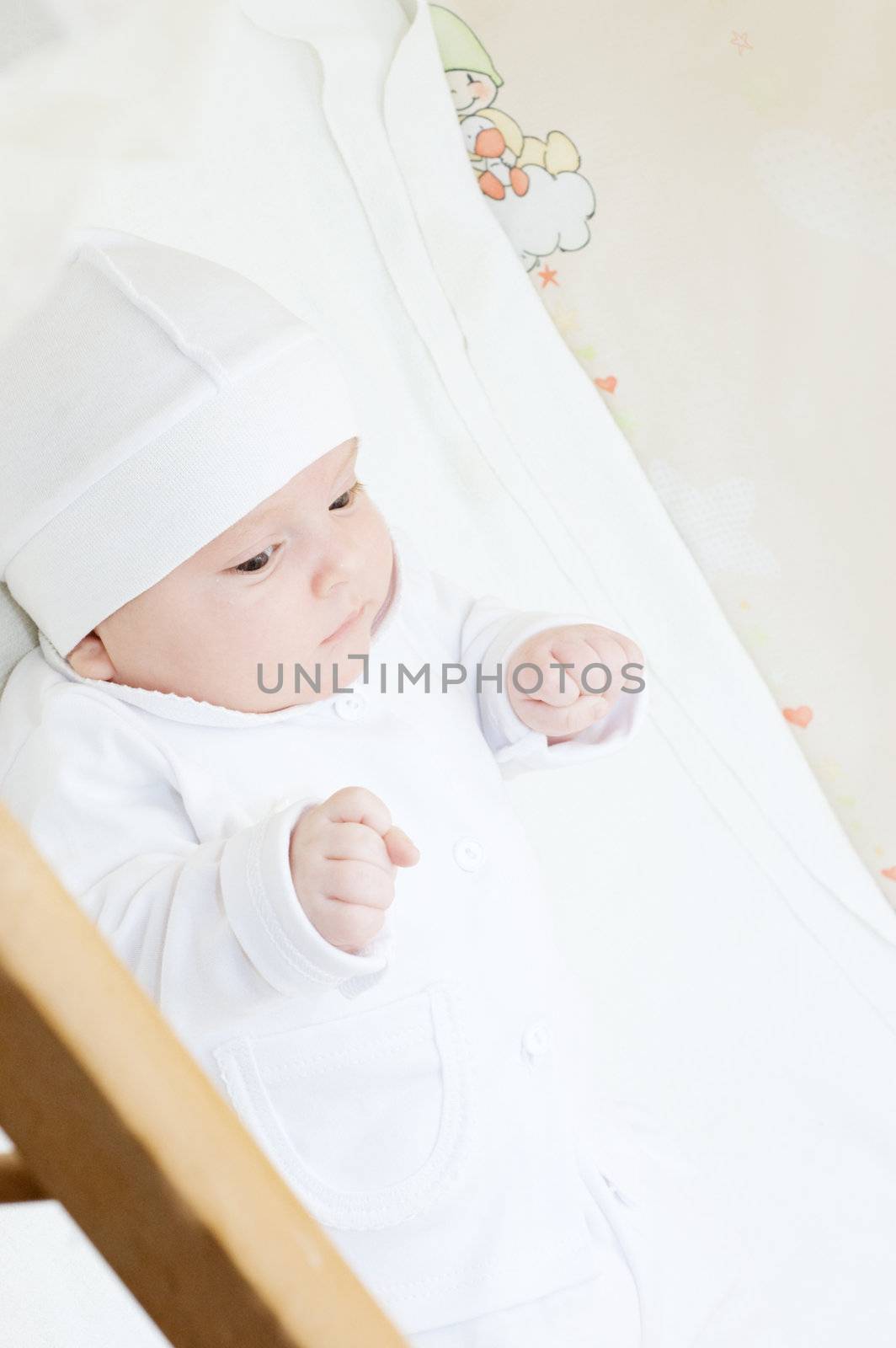 Little baby lying in crib