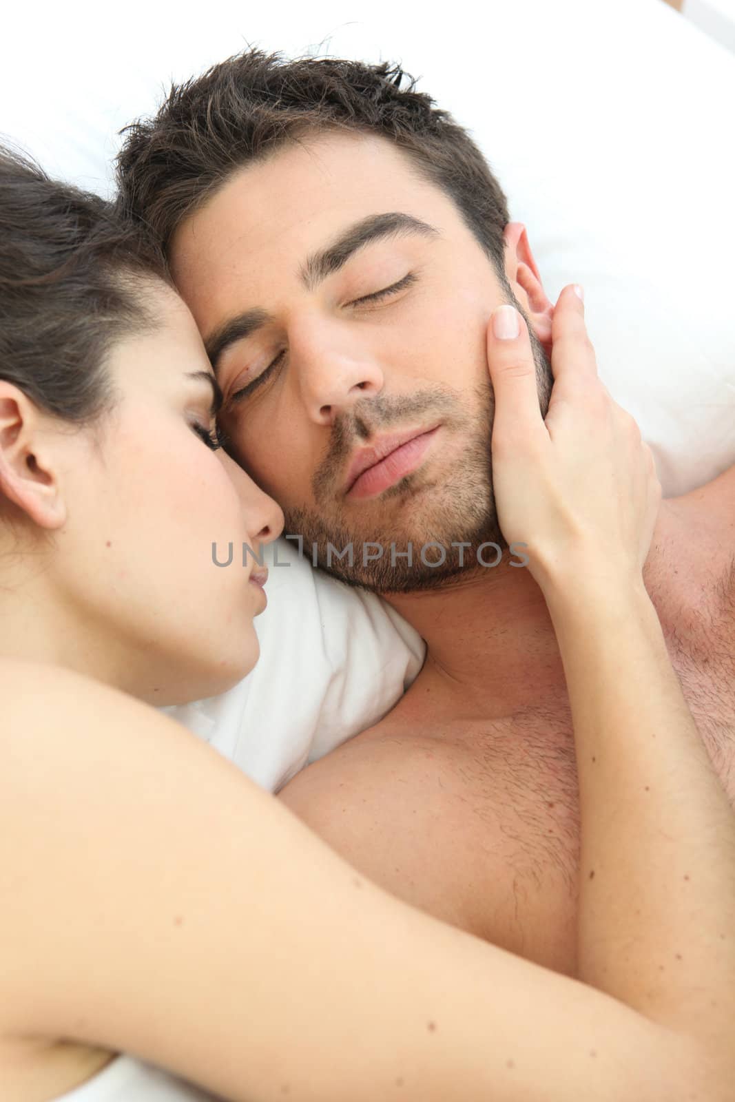 Couple asleep in bed
