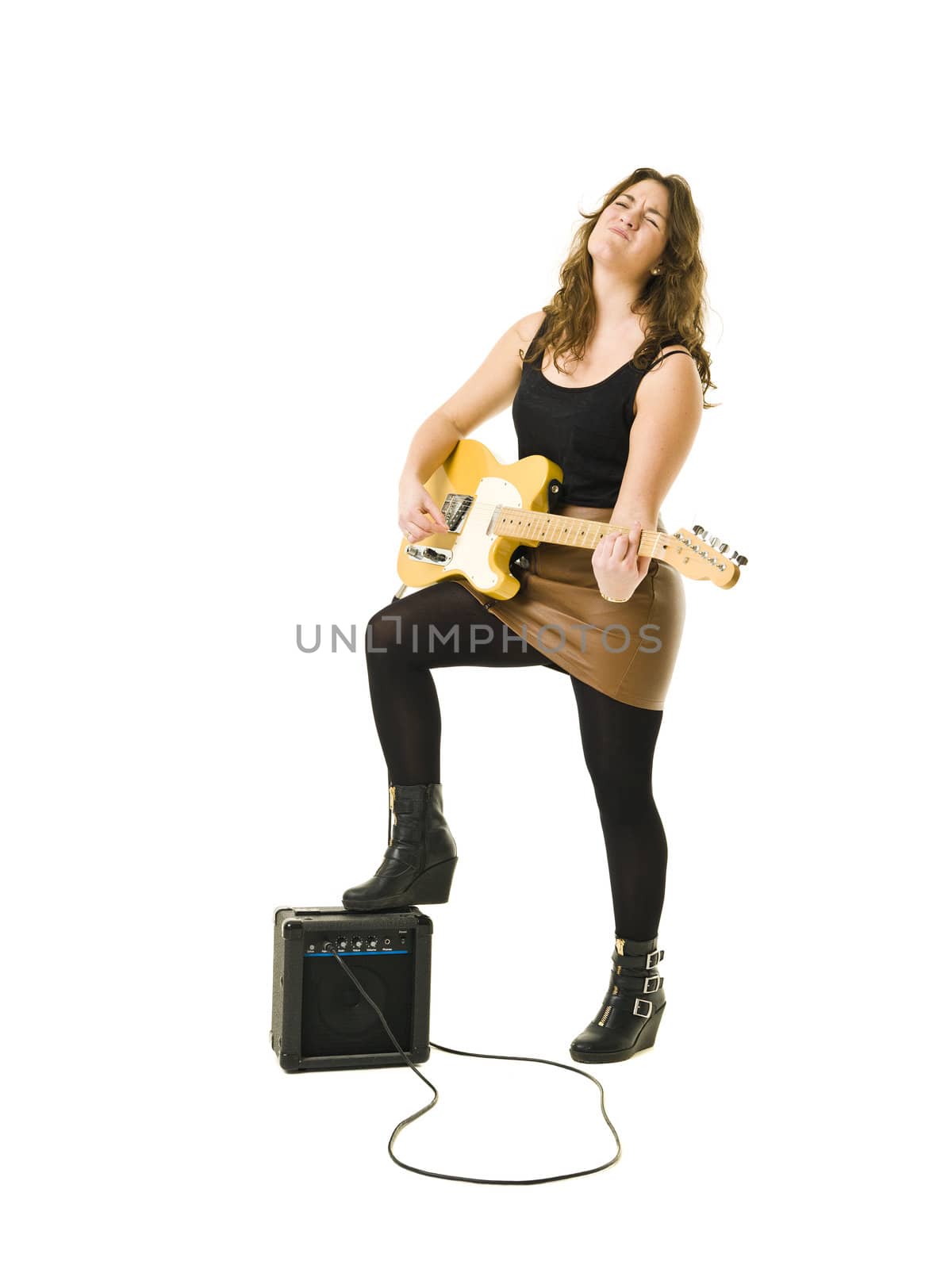 Young woman playing electric guitar isolated on white background