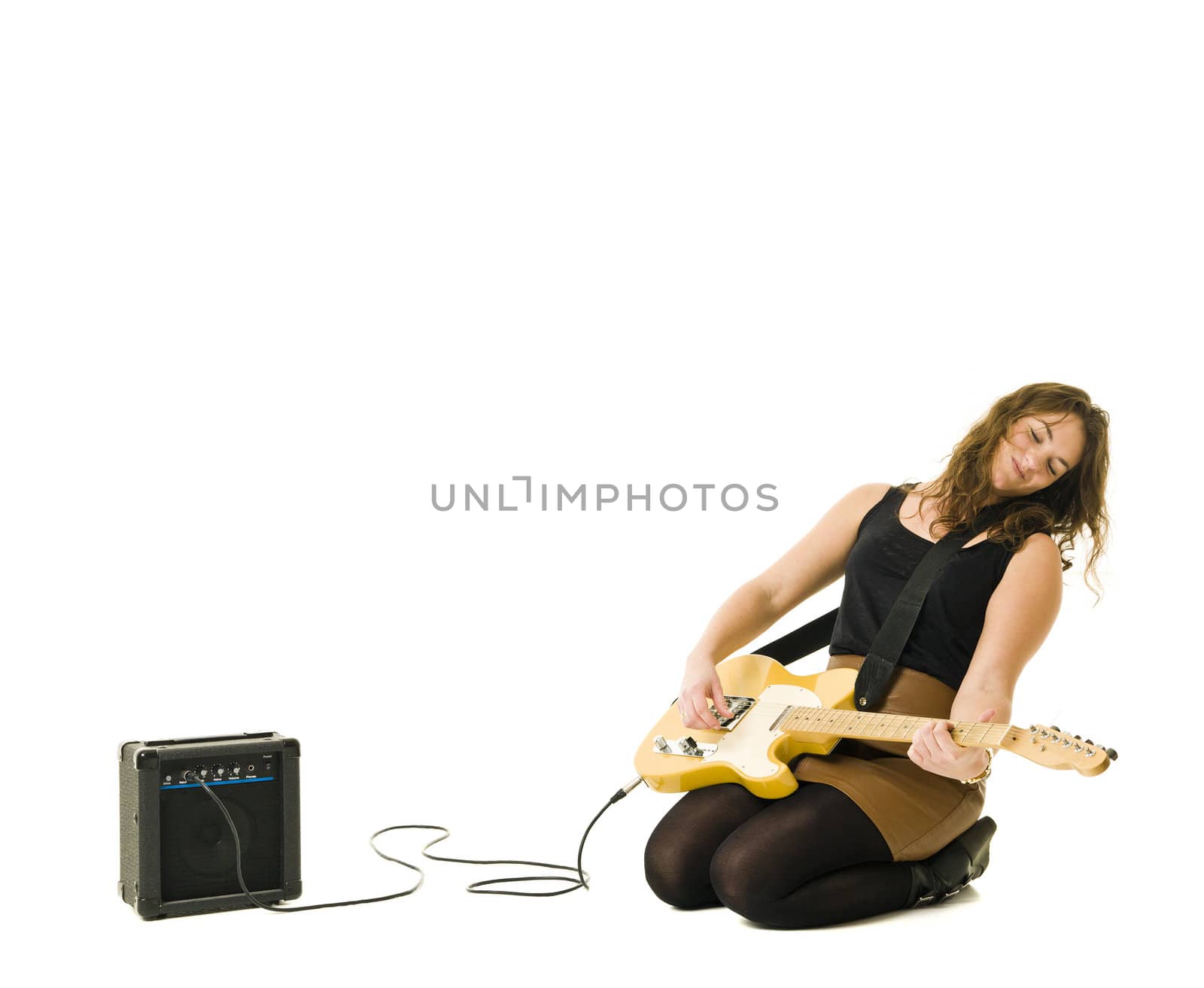 Young woman playing electric guitar isolated on white background