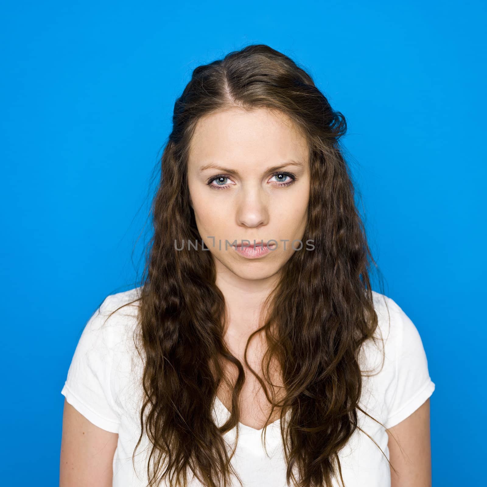 Portrait of a young girl on blue background