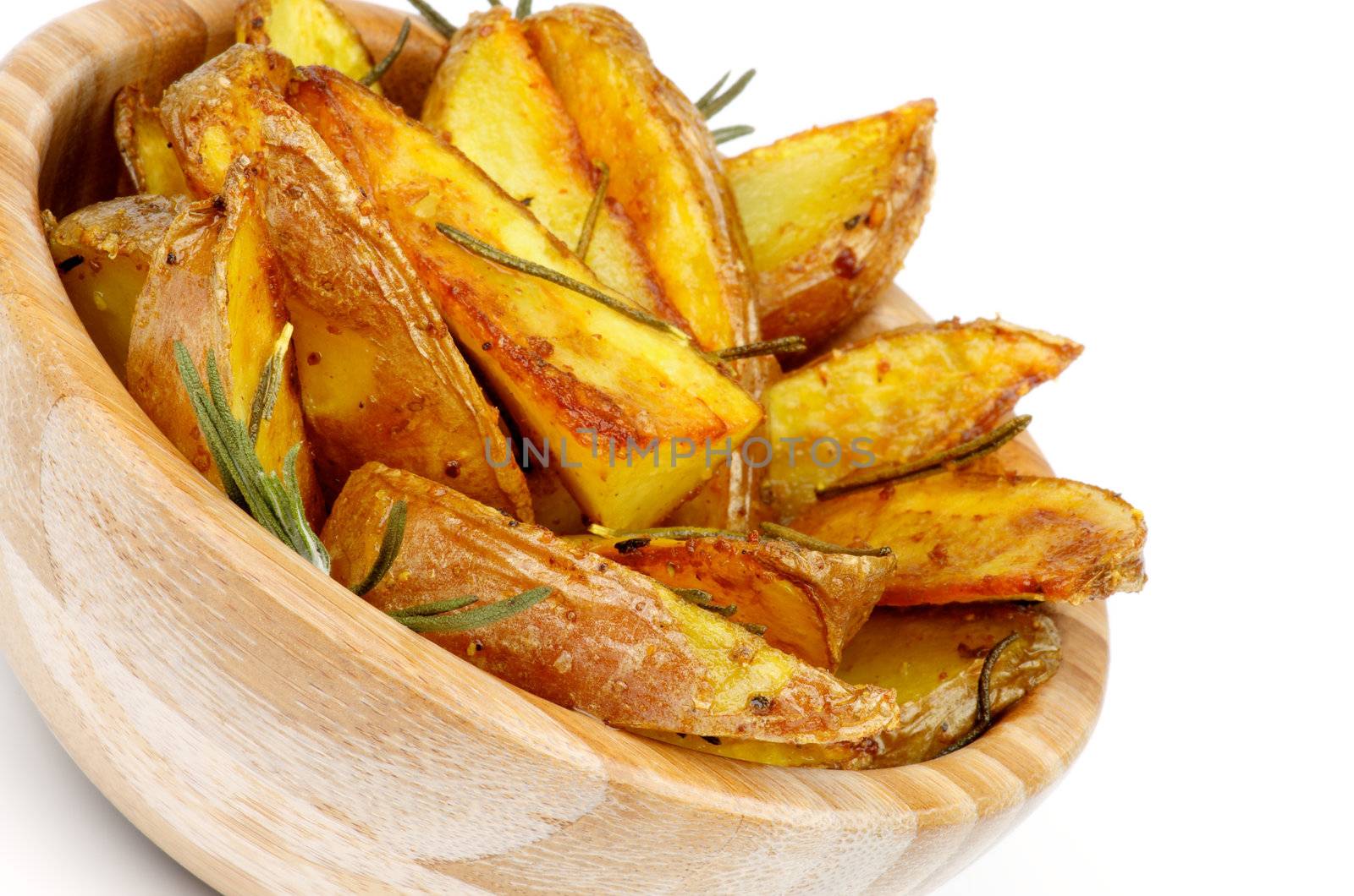 Wooden Bowl with Roasted in Rosemary Potato Wedges closeup on white background