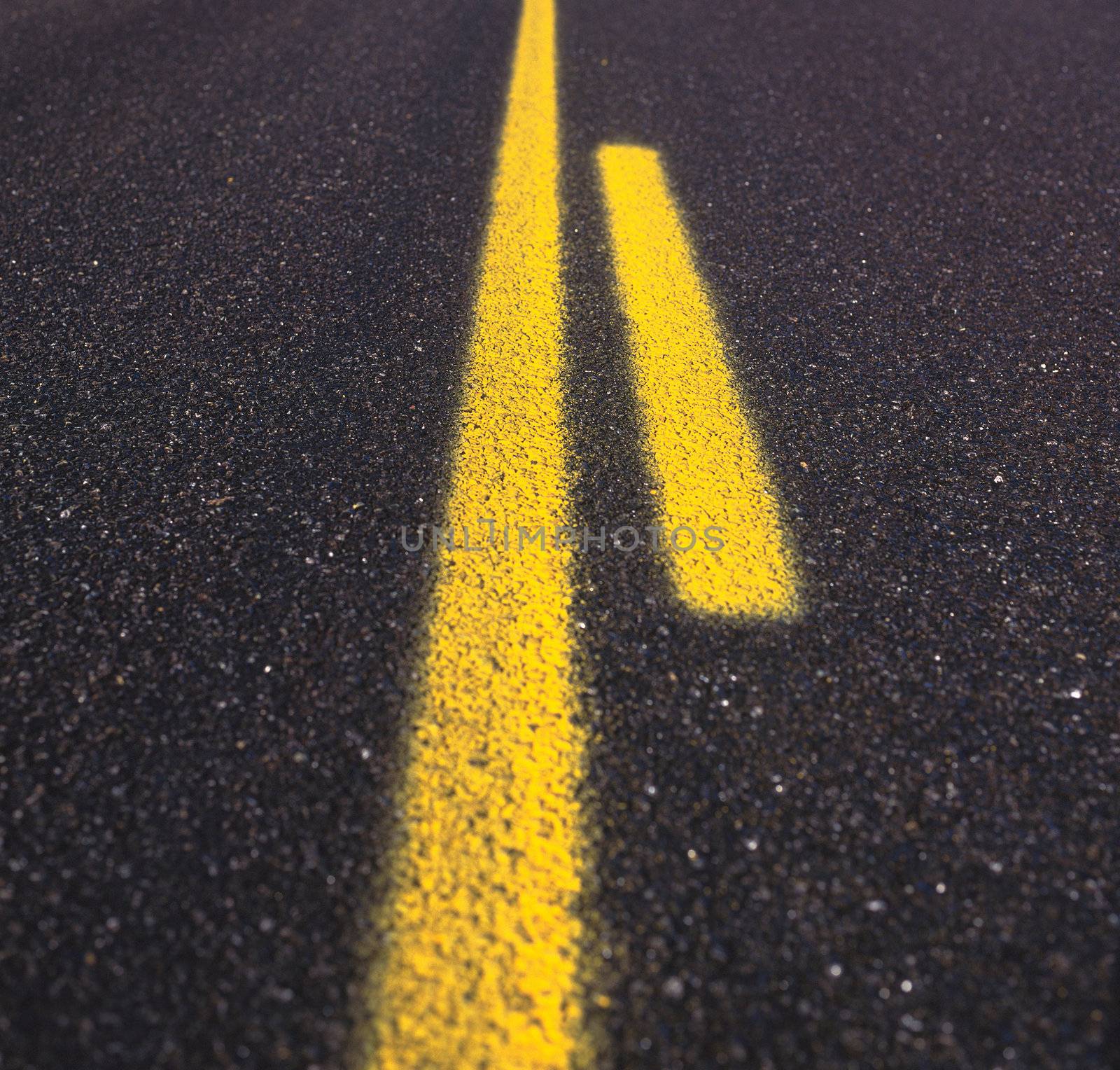 Asphalt road texture with yellow stripe by ozaiachin