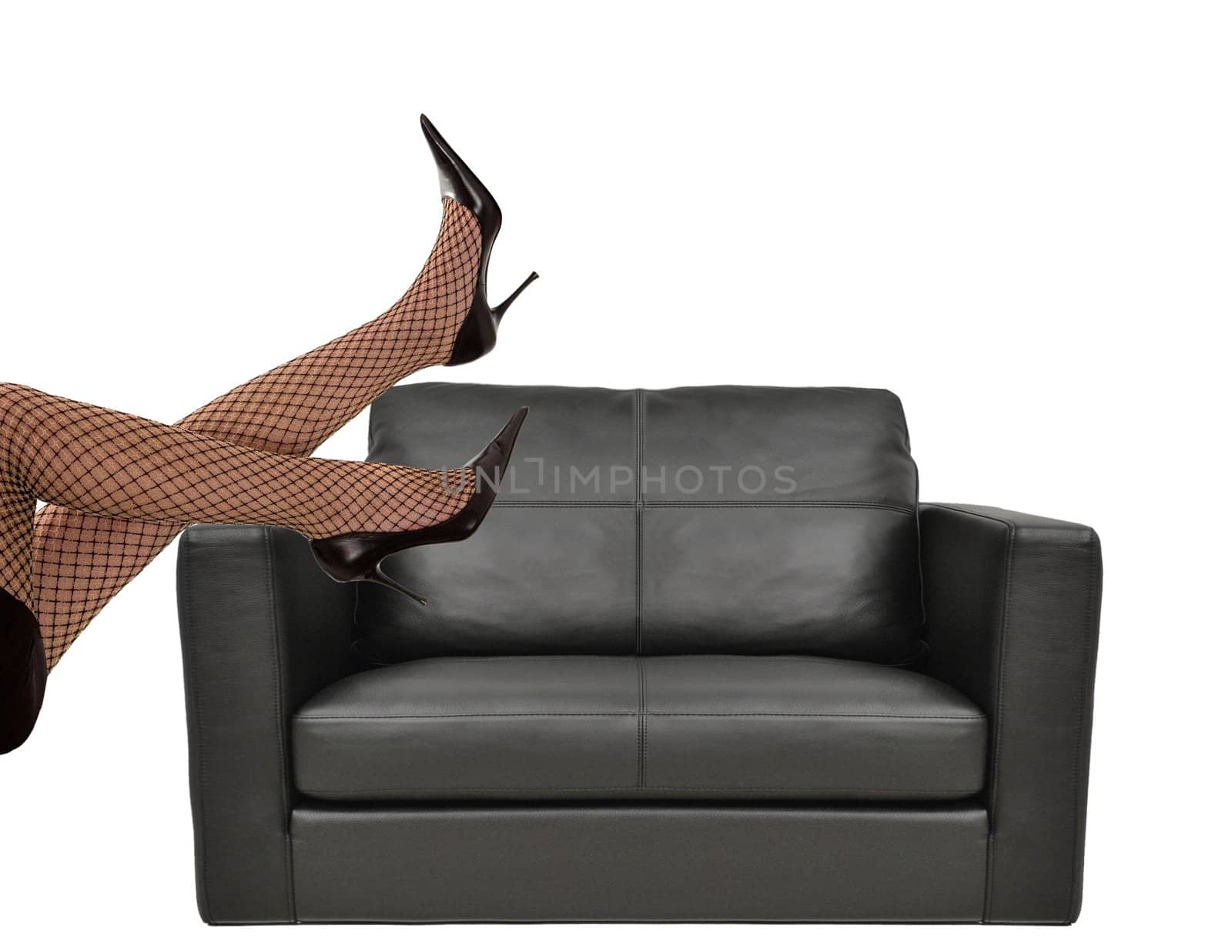 Woman with beautiful legs sitting on sofa