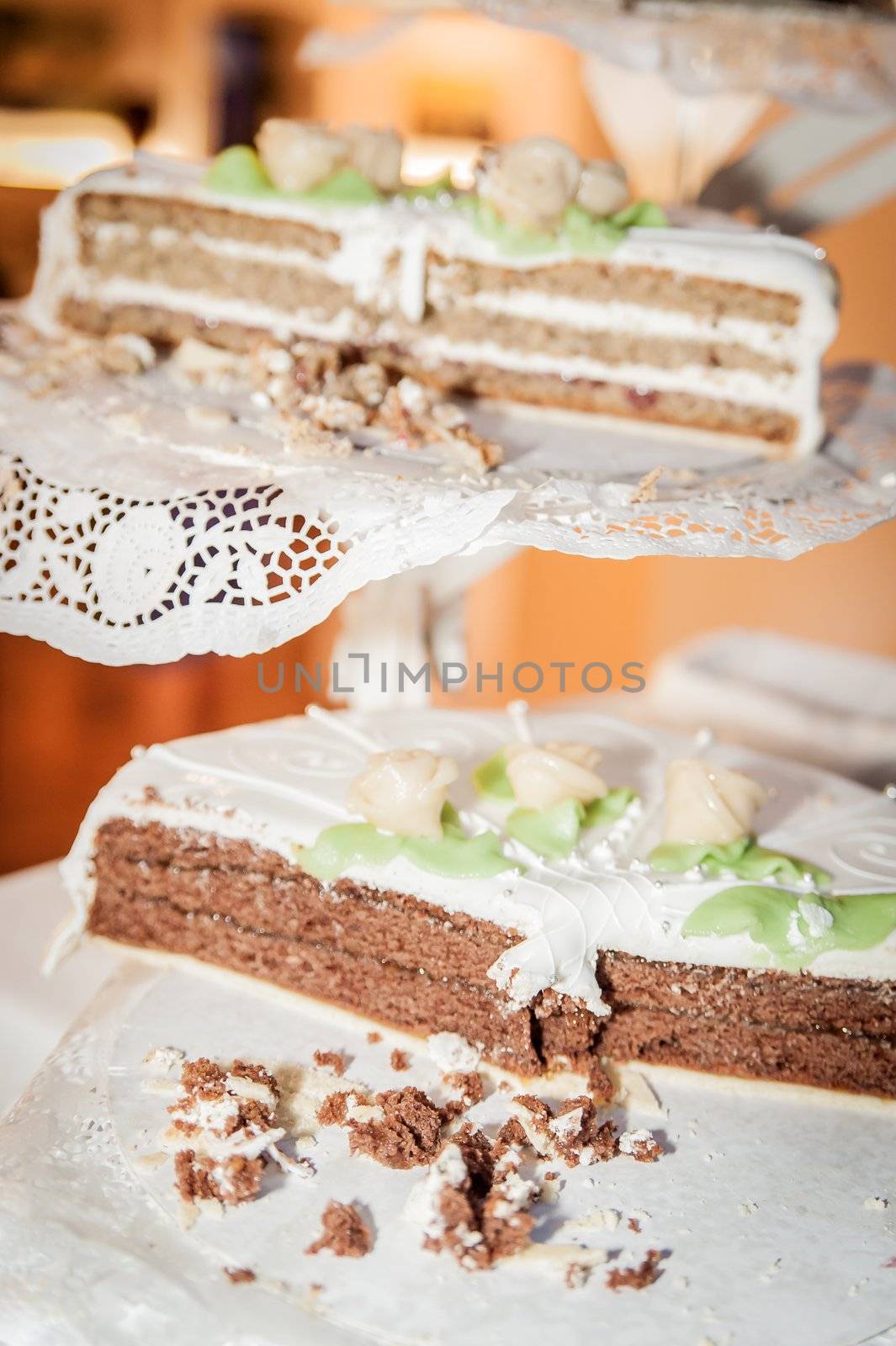 Partially eaten wedding cake on a cake stand