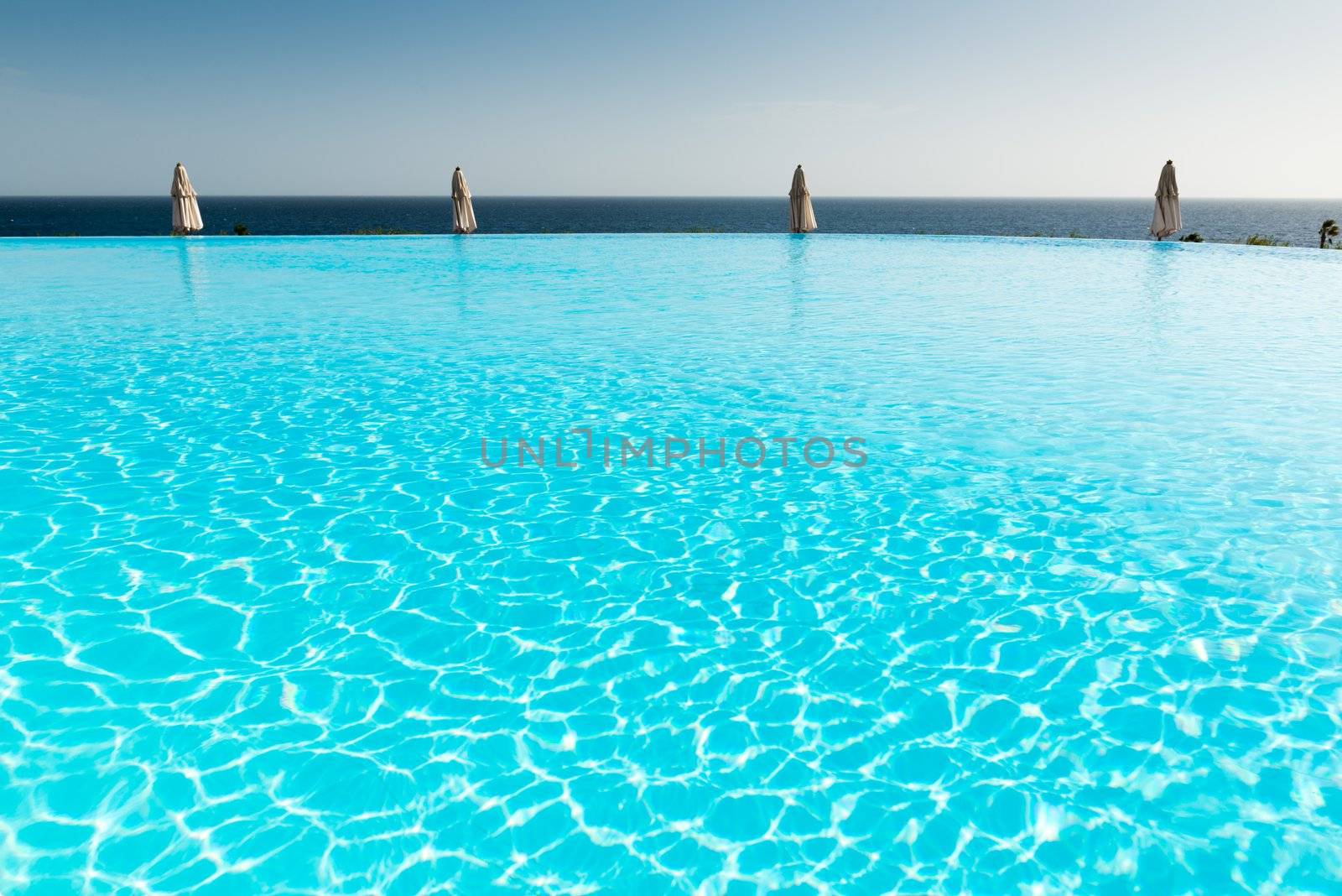 Empty blue infinity pool in crisp morning light