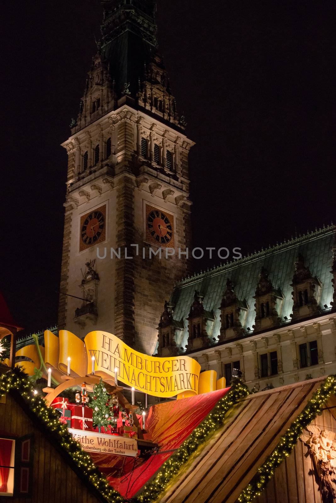 HAMBURG - DECEMBER 1, 2012: People visit traditional Christmas market in Hamburg, Germany on December 1, 2012. The famous Hamburg Christmas market is located around the town hall and is a popular tourist attraction due to its gorgeous decorated stands.