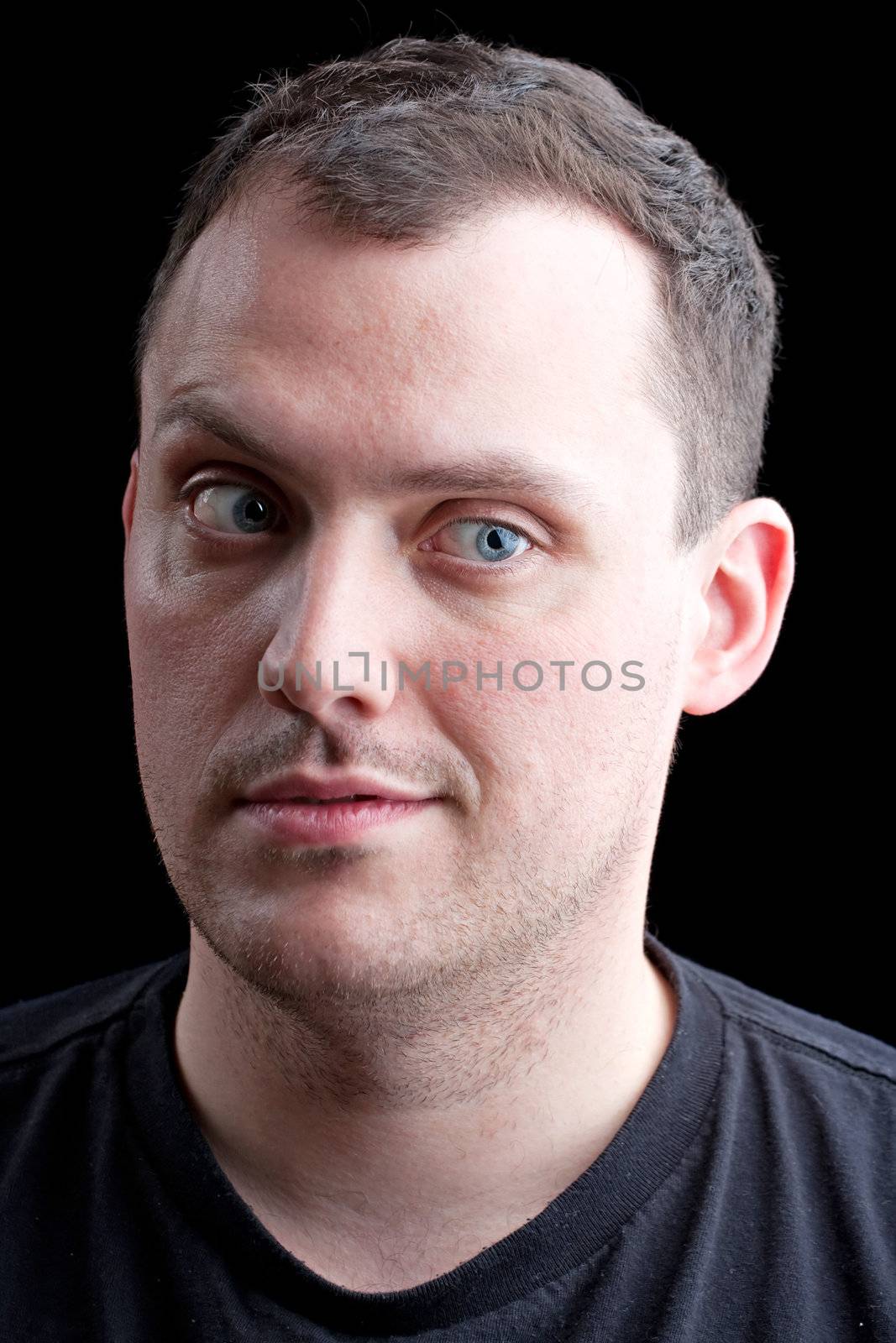 Worrying man with a skeptical or doubtful expression on his face isolated over a black background.