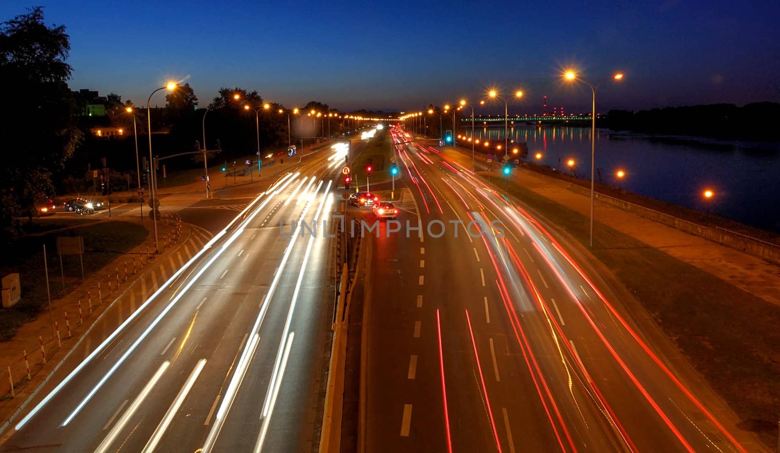warsaw traffic near bridge at night by arnelsr