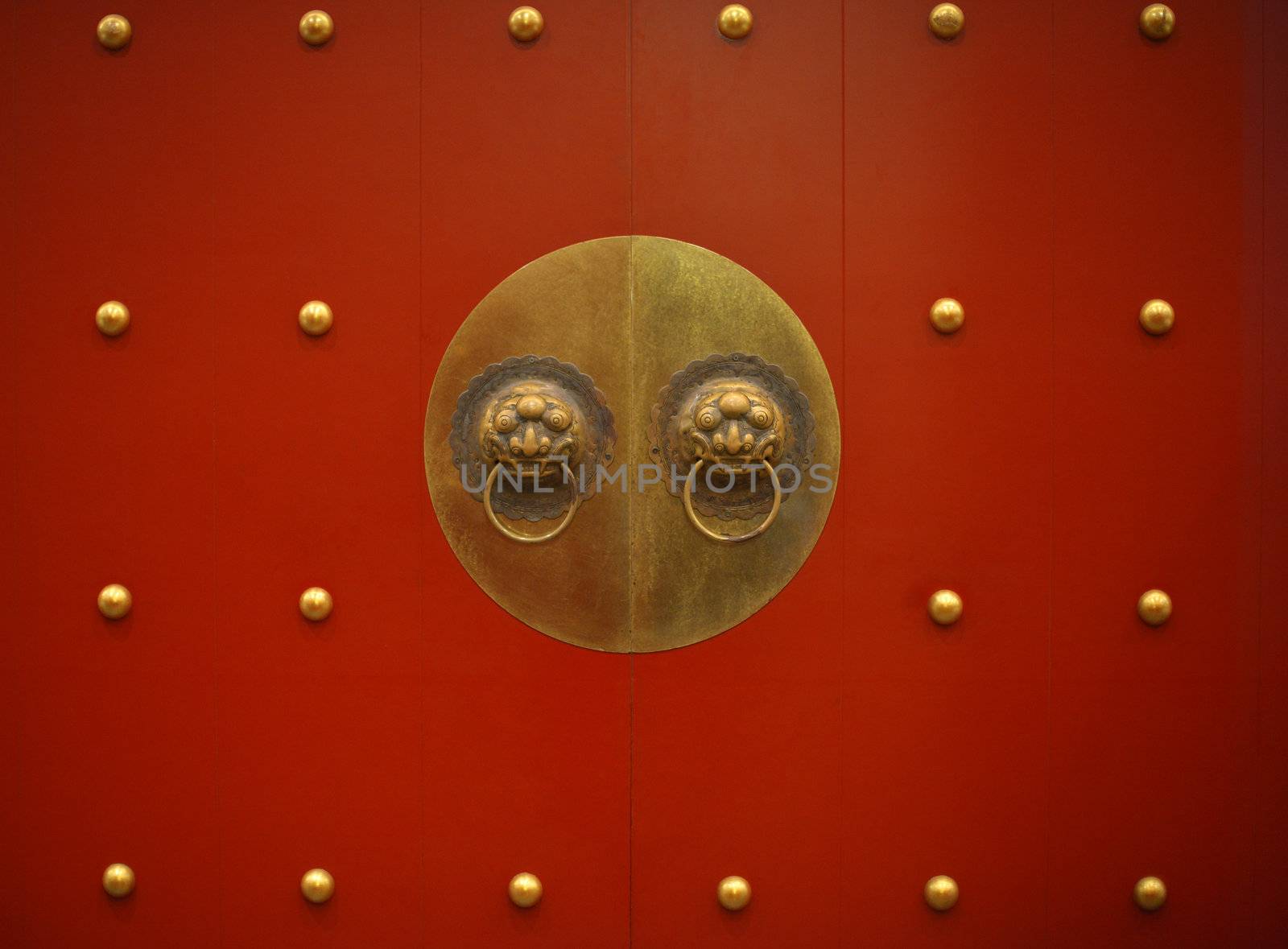 Typical old Chinese red door with bronze dragon knocker