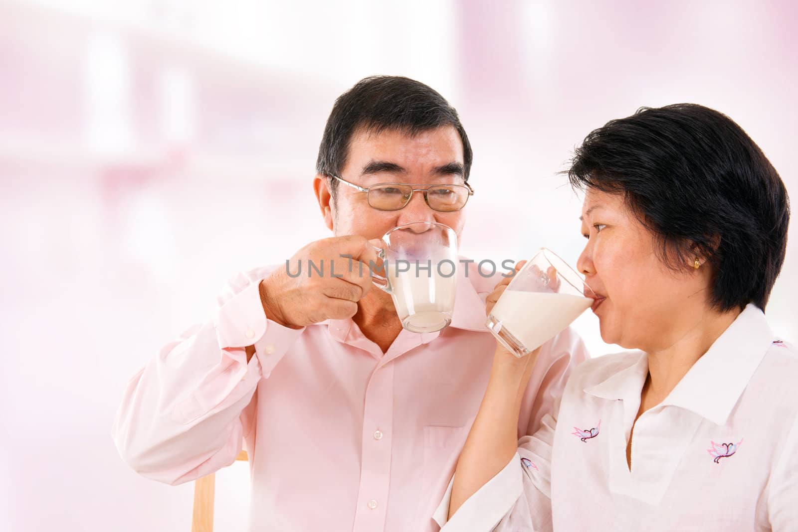 Asian mature couple drinking soy milk  by szefei