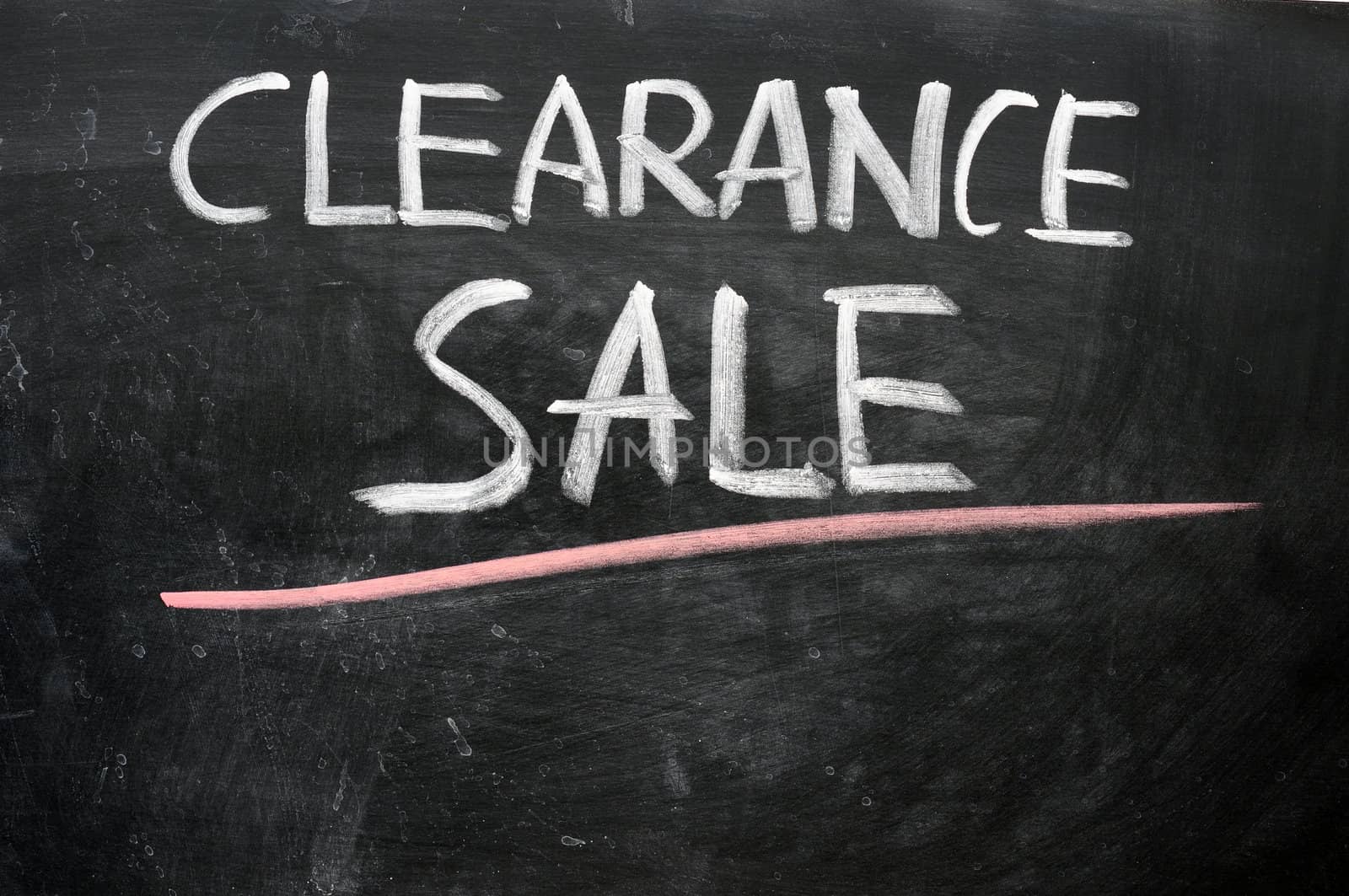 Clearance sale written with chalk on a blackboard