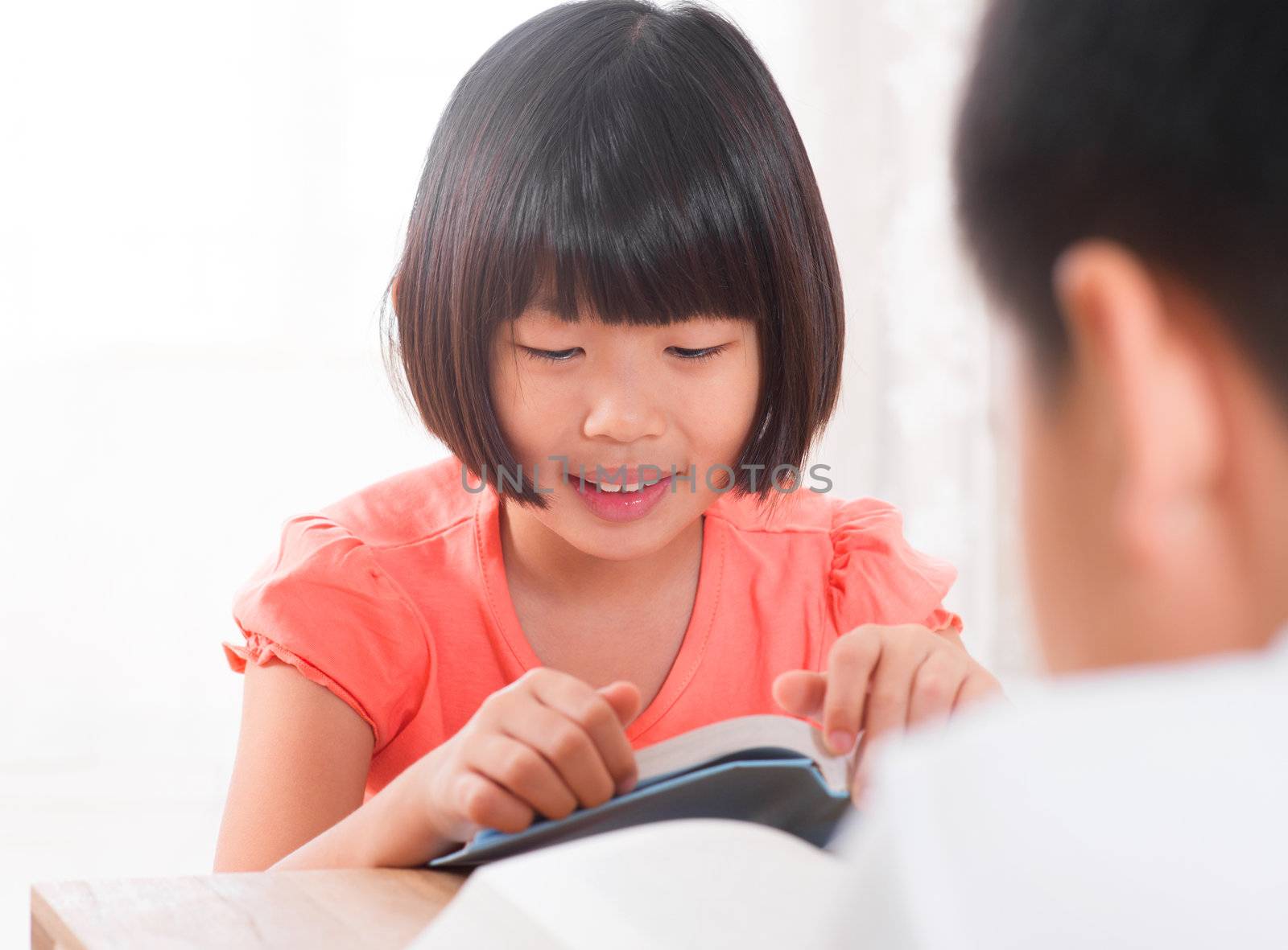 Southeast Asian children reading book at home, Asian family living lifestyle.