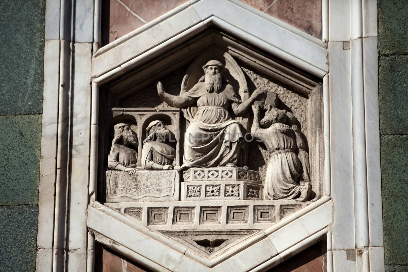 Florence - The hexagonal Relief on the Giottos' Campanile.The hexagonal panels on the lower level depict the history of mankind, inspired by Genesis.