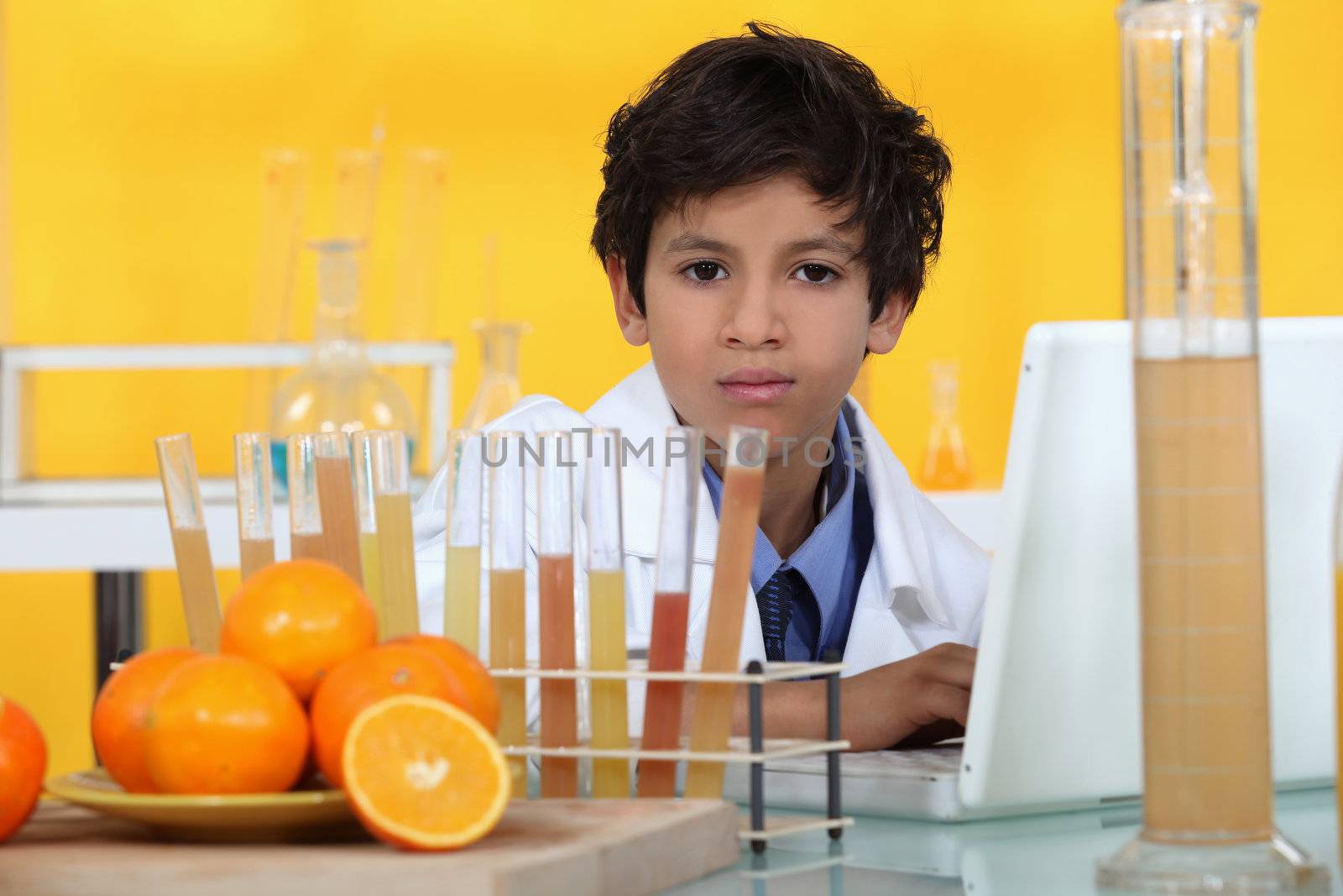 little boy analyzing oranges in the laboratory