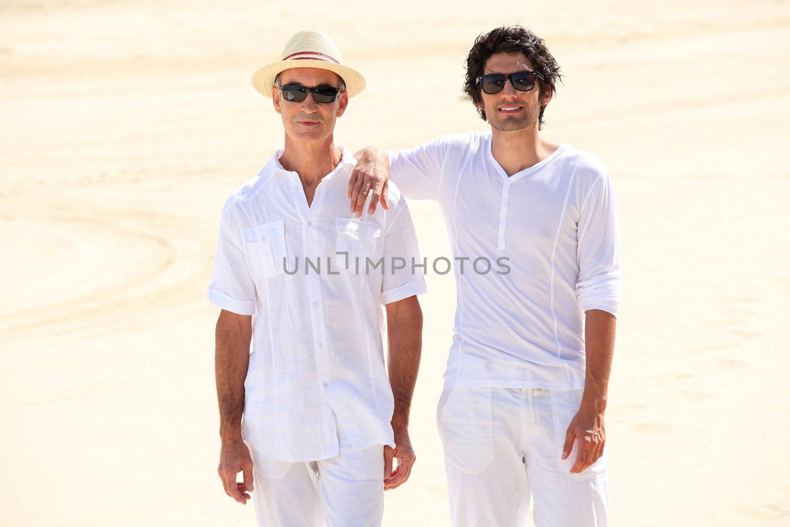 Father and son stood on beach
